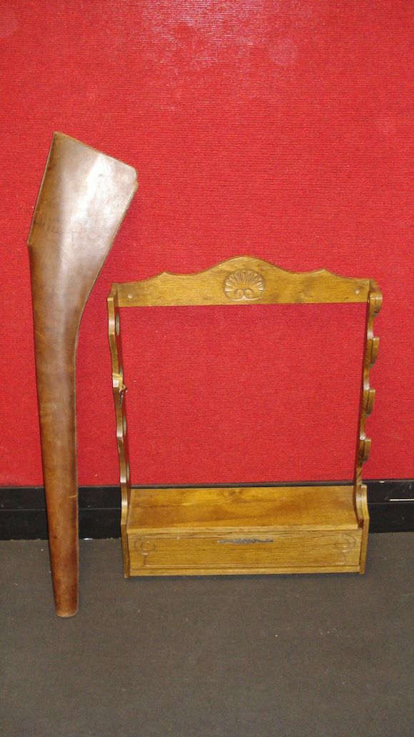 Bonhams : A wall-mounted oak gun rack