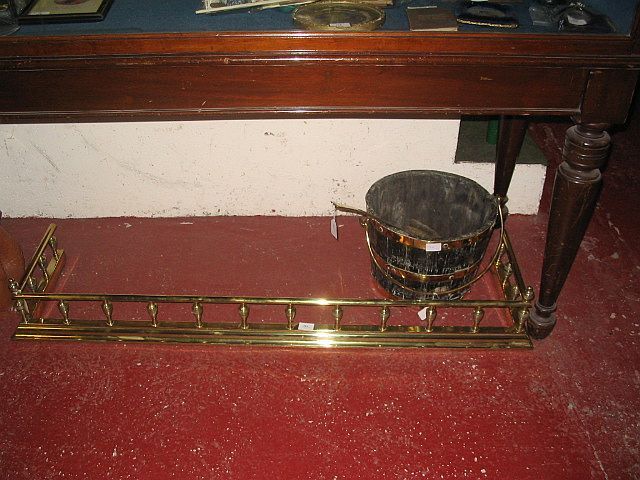 A brass fire curb