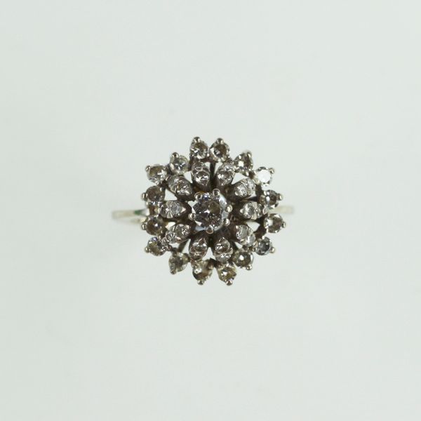 A domed diamond cluster ring