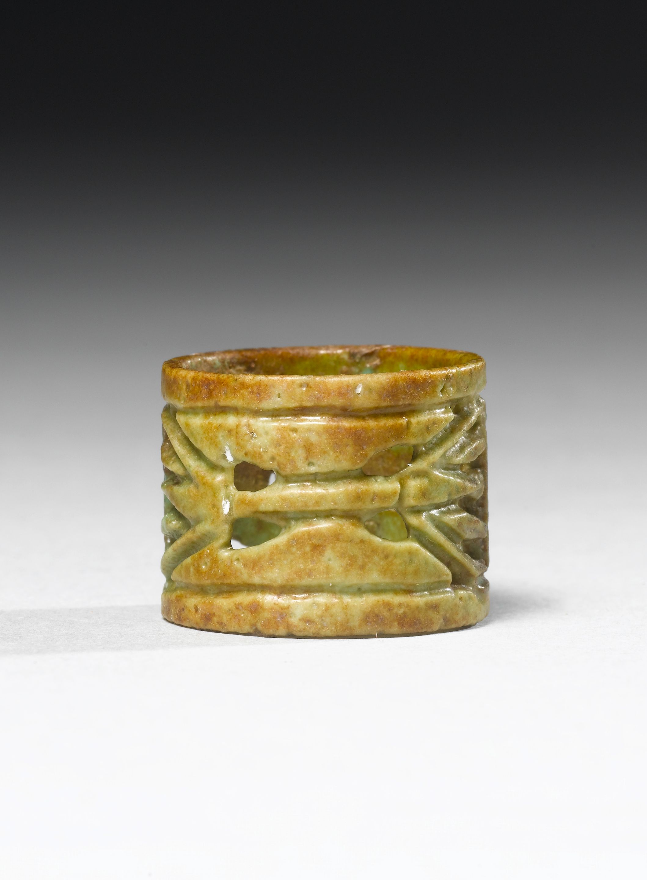 An Egyptian green glazed composition openwork ring