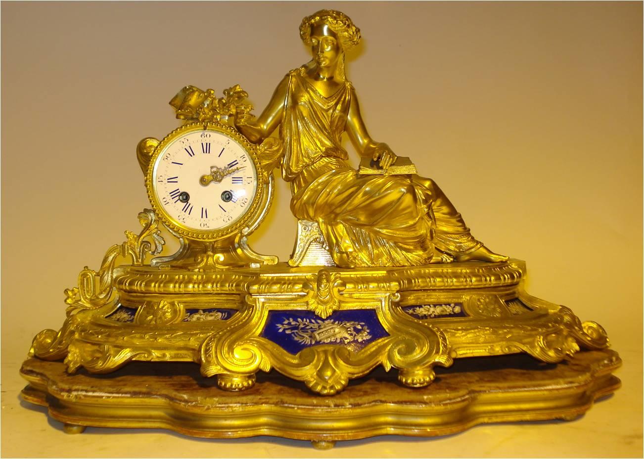 A late 19th century French gilt brass and porcelain-mounted mantel clock,