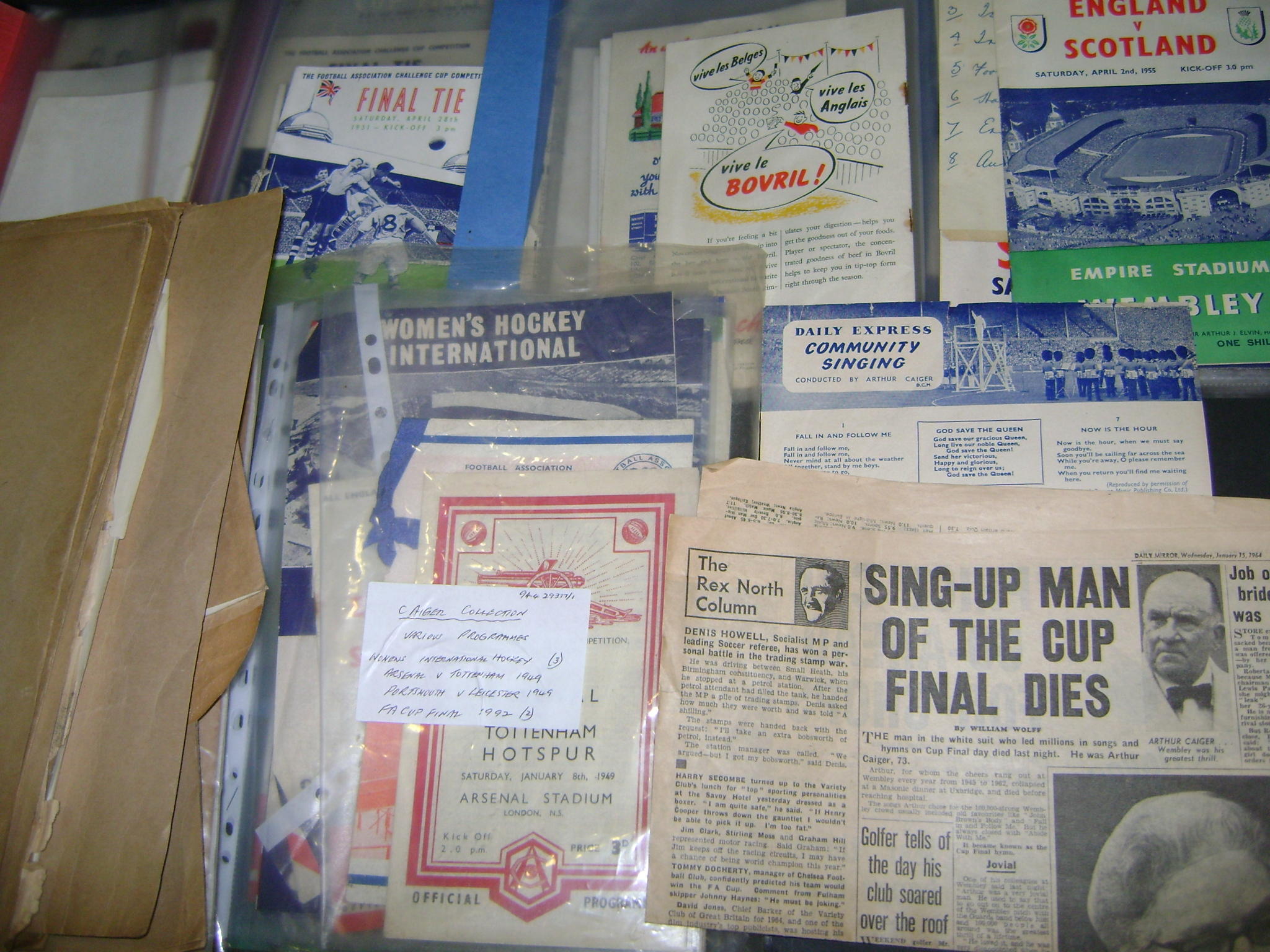 A collection of football programmes and song sheets related to Arthur Caiger