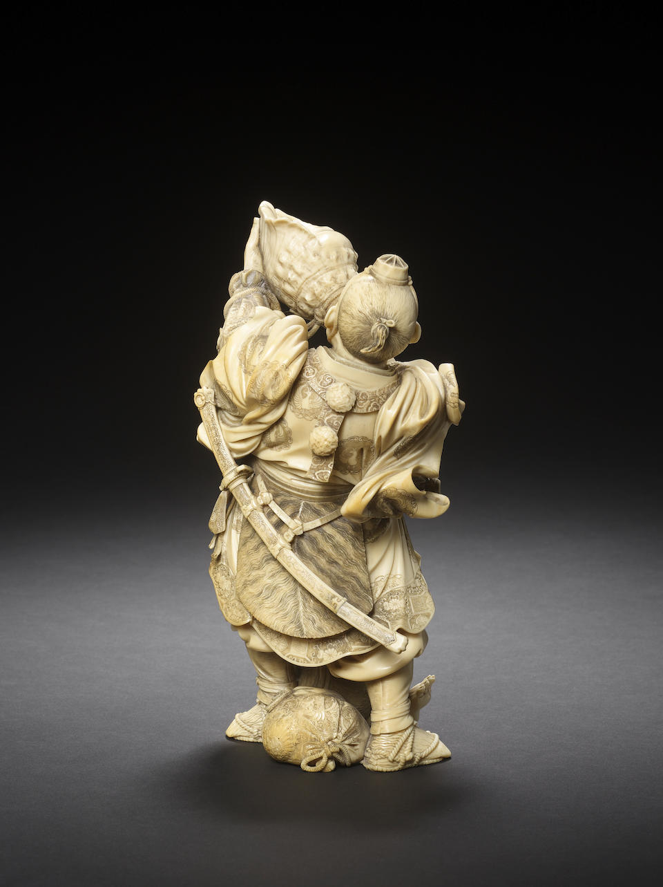 An elaborately carved ivory figural okimono group of Musashibo Benkei and oni By Shimamura Toshimitsu of Tokyo, Meiji Period
