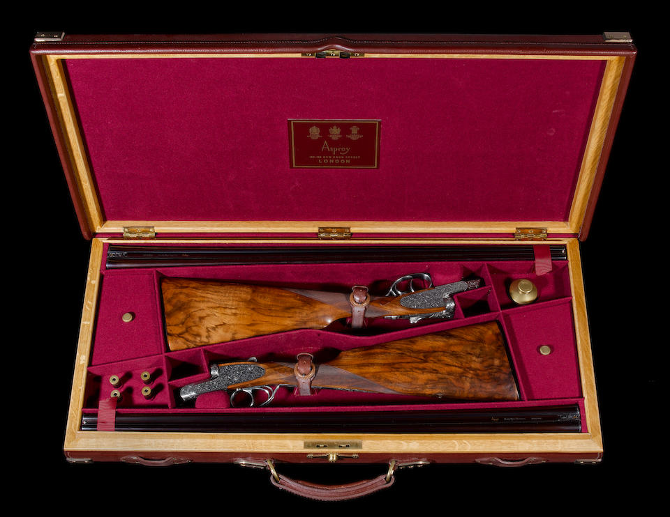 A fine pair of Portsmouth-engraved .410 (3in) self-opening sidelock ejector guns by Asprey, no. 1523/4 In their brass-mounted oak and leather case with makers accessories