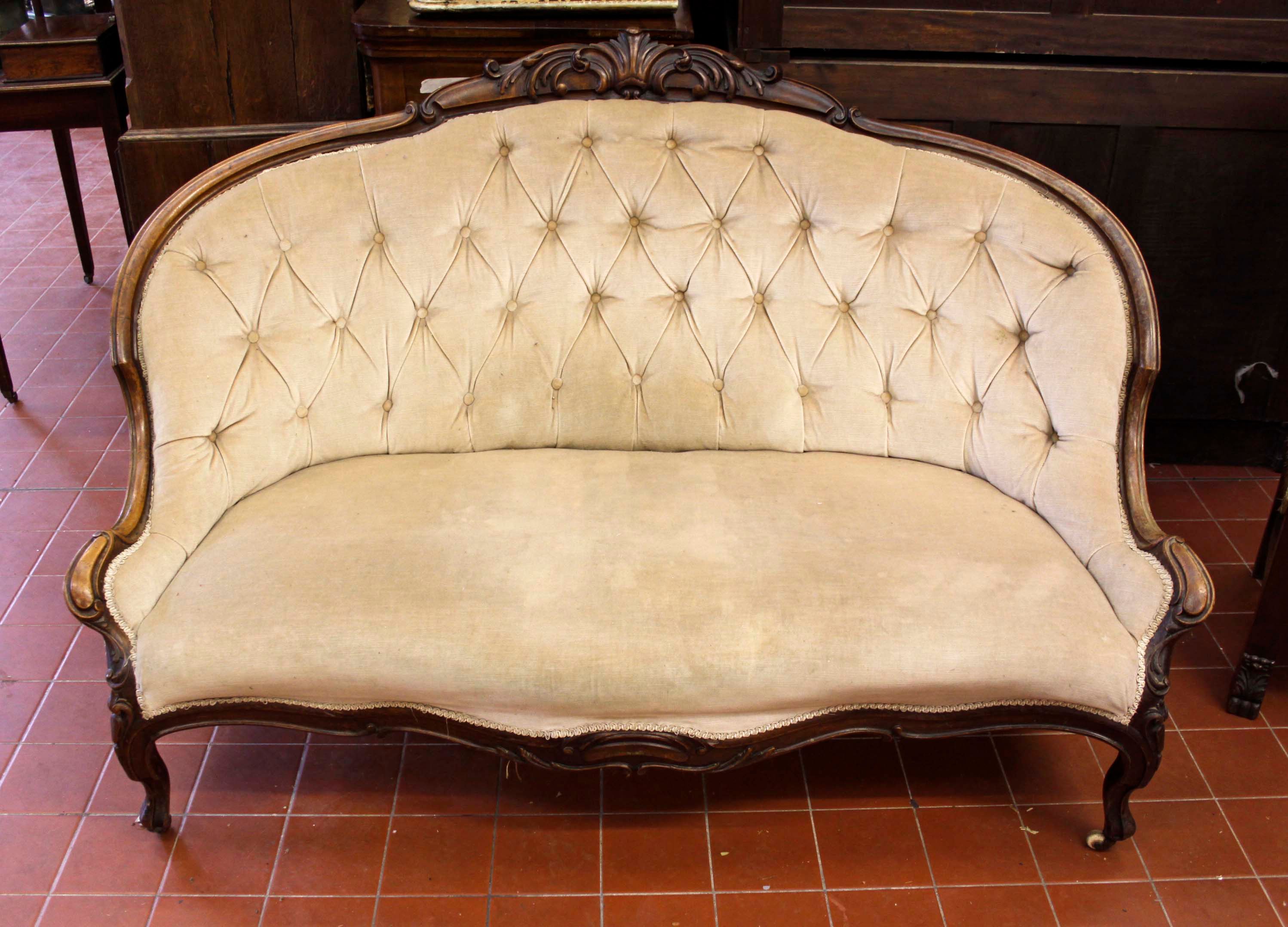 A Victorian walnut showframe sofa,