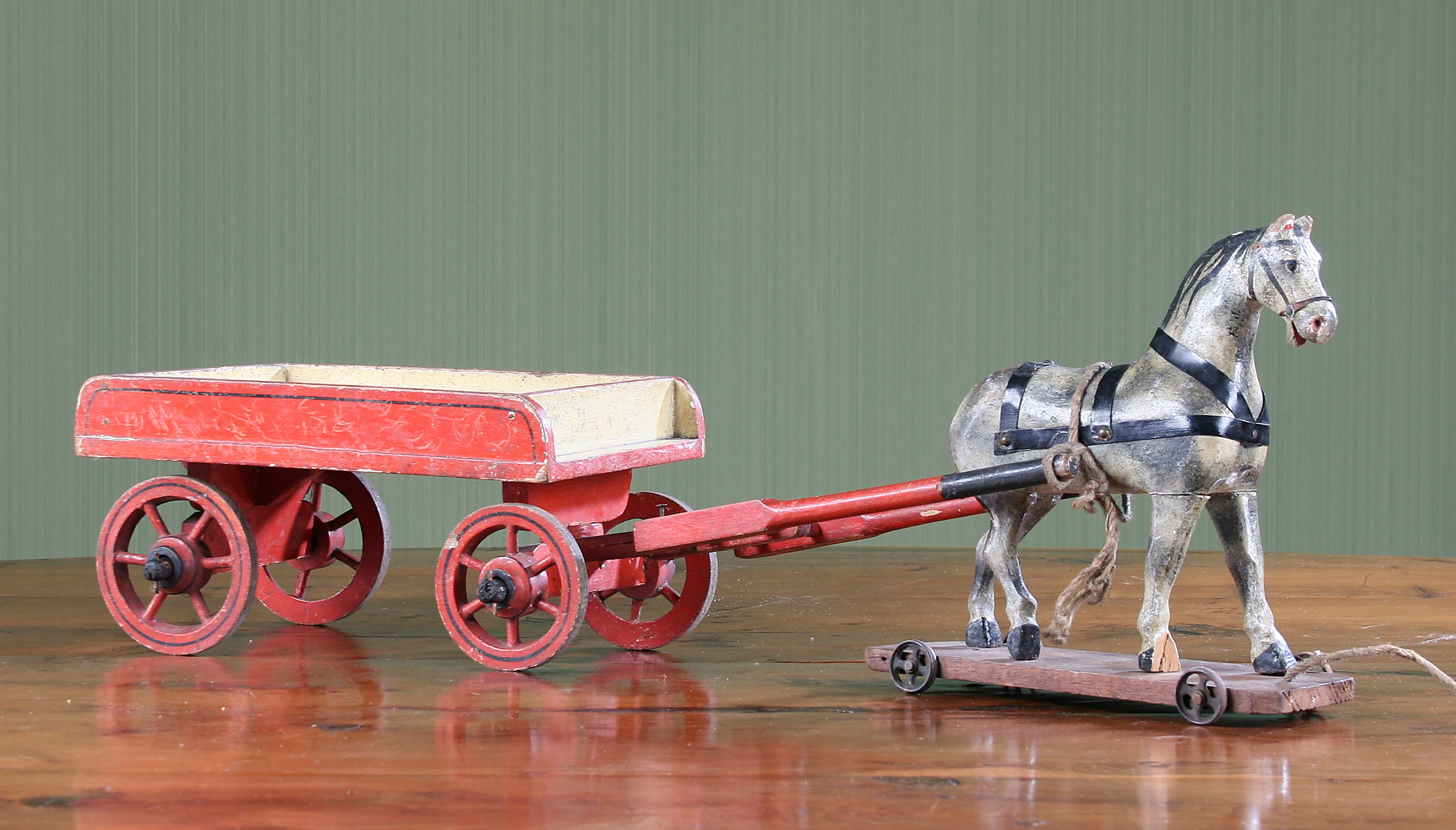 Bonhams Folk Art A painted wooden toy horse and cart