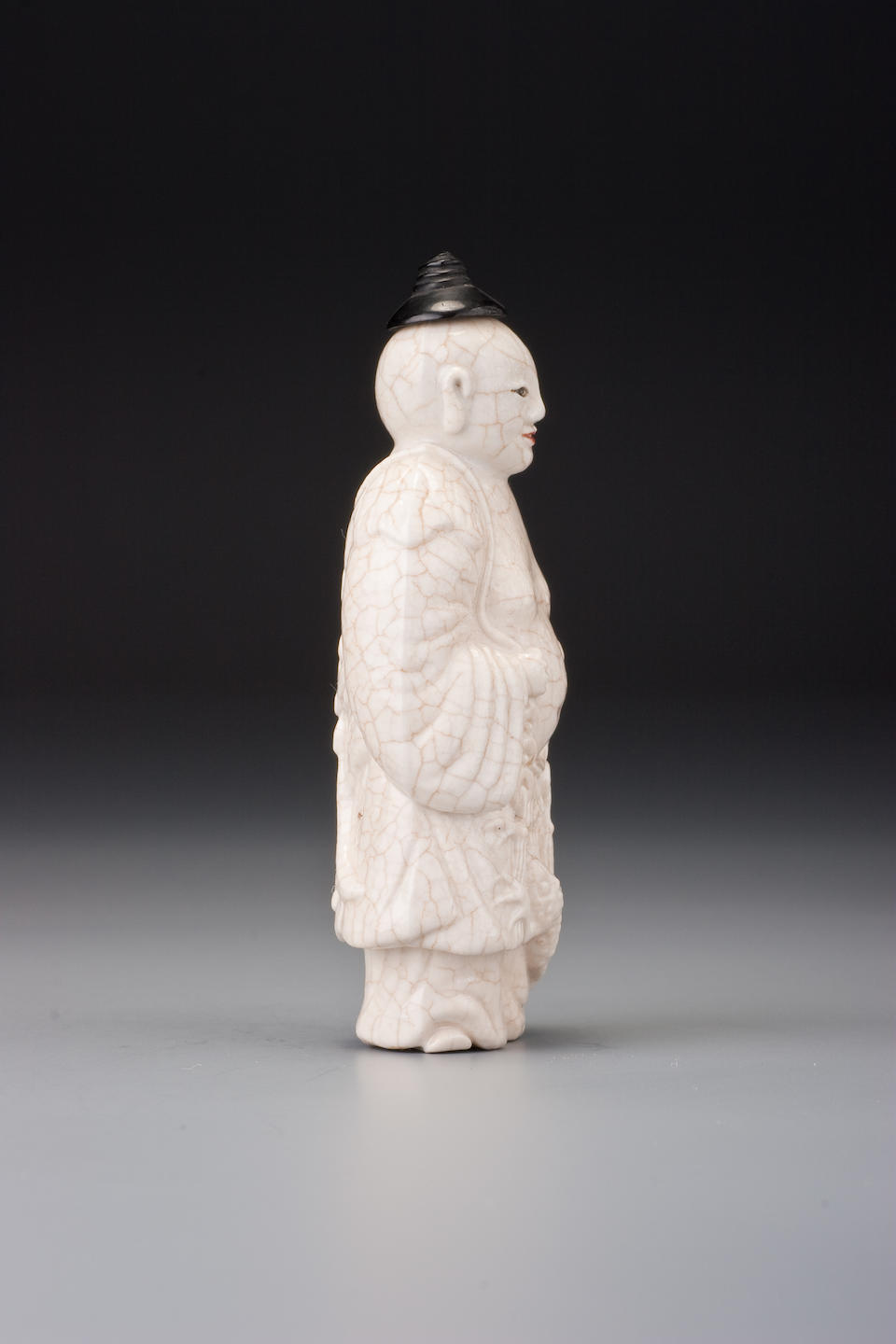 Bonhams : A moulded soft-paste porcelain 'Liu Hai' snuff bottle
