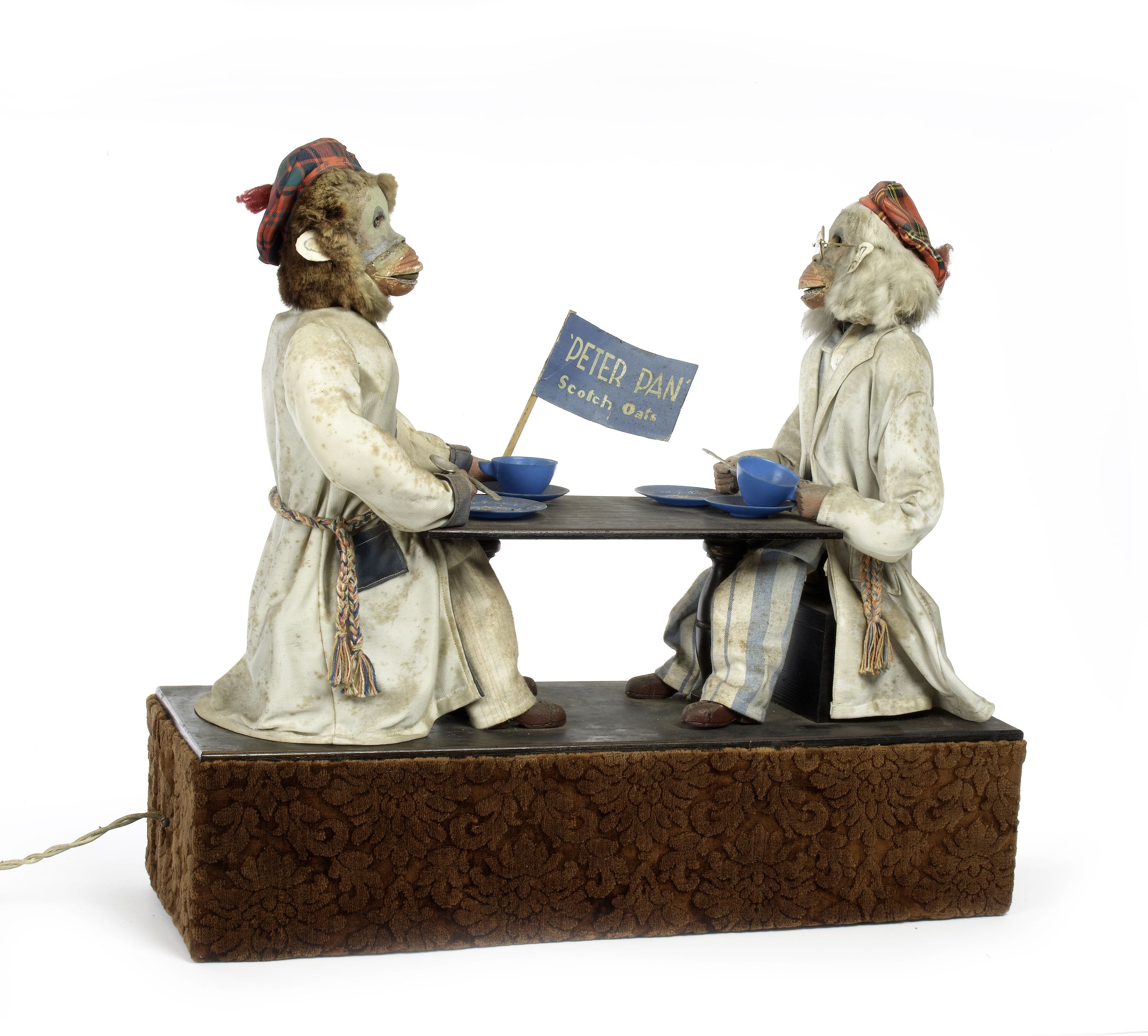 Bonhams A rare electric 'Peter Pan Oats' double monkey automaton, by