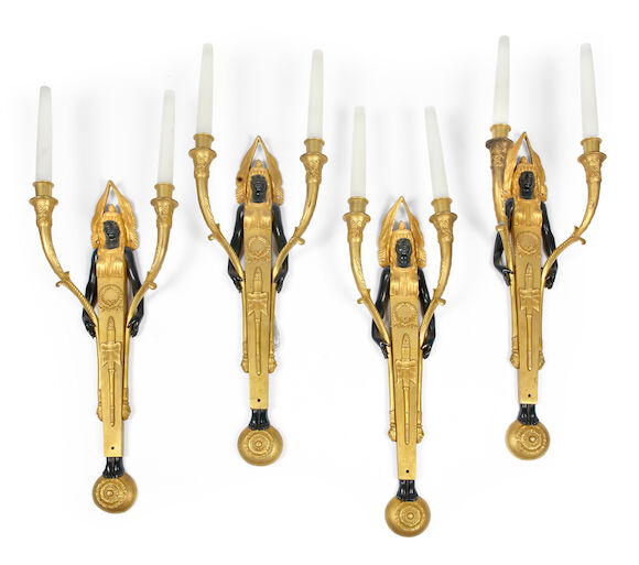 Bonhams : A set of four Empire style gilt bronze and bronze wall appliqués