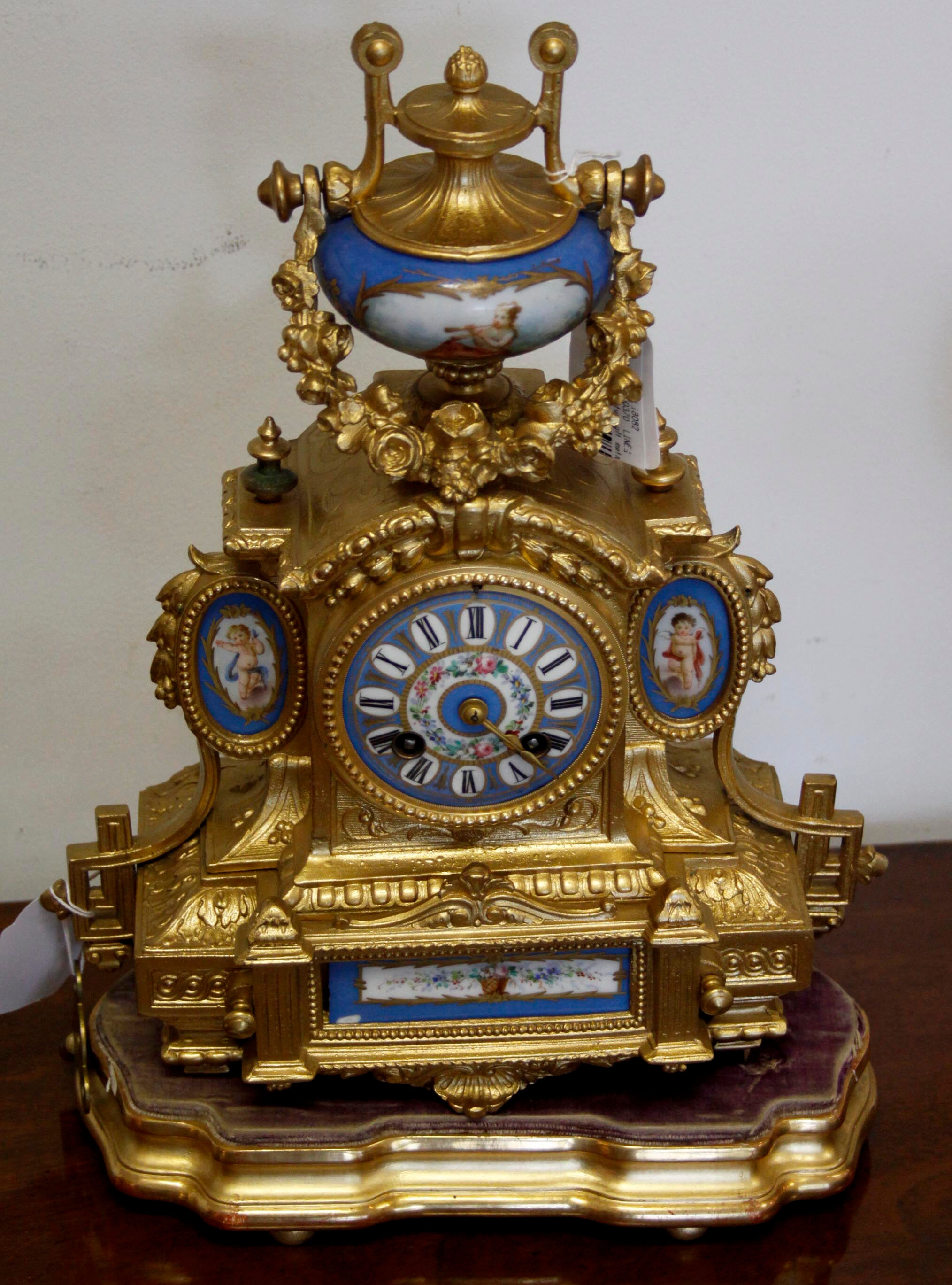 A late 19th Century gilt metal and Sevres style mounted mantel clock ...