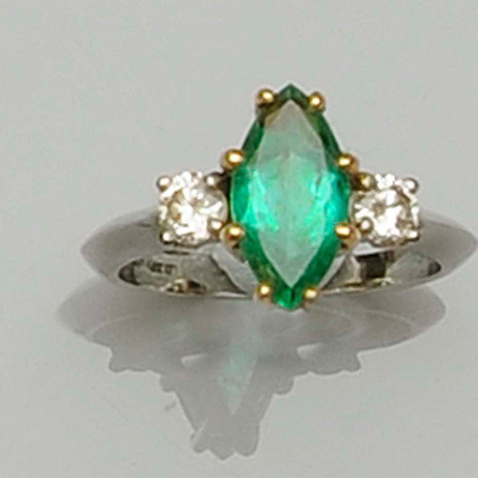 An emerald and diamond ring