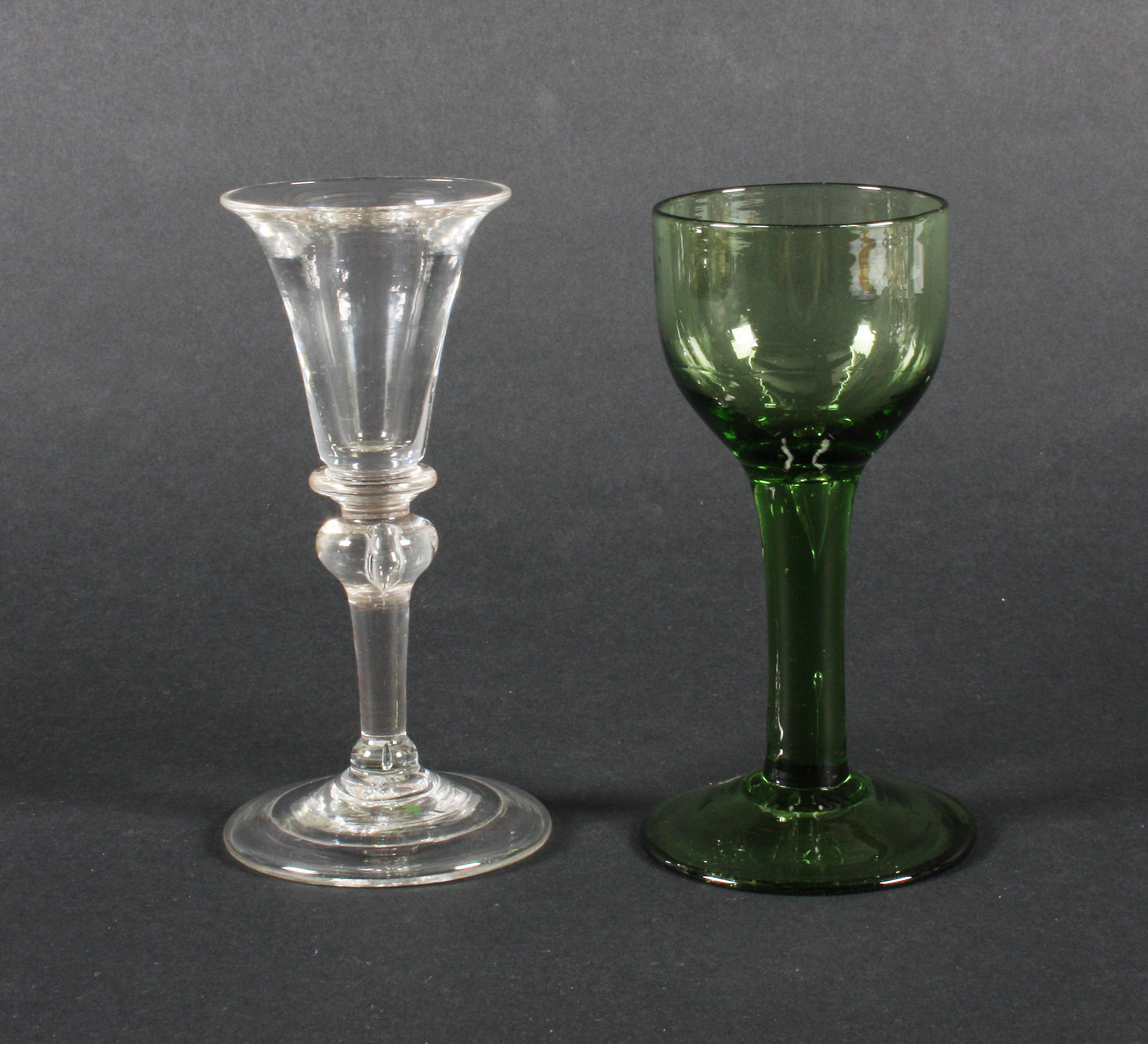A plain stem gin glass and a green-tinted plain stem wine glass