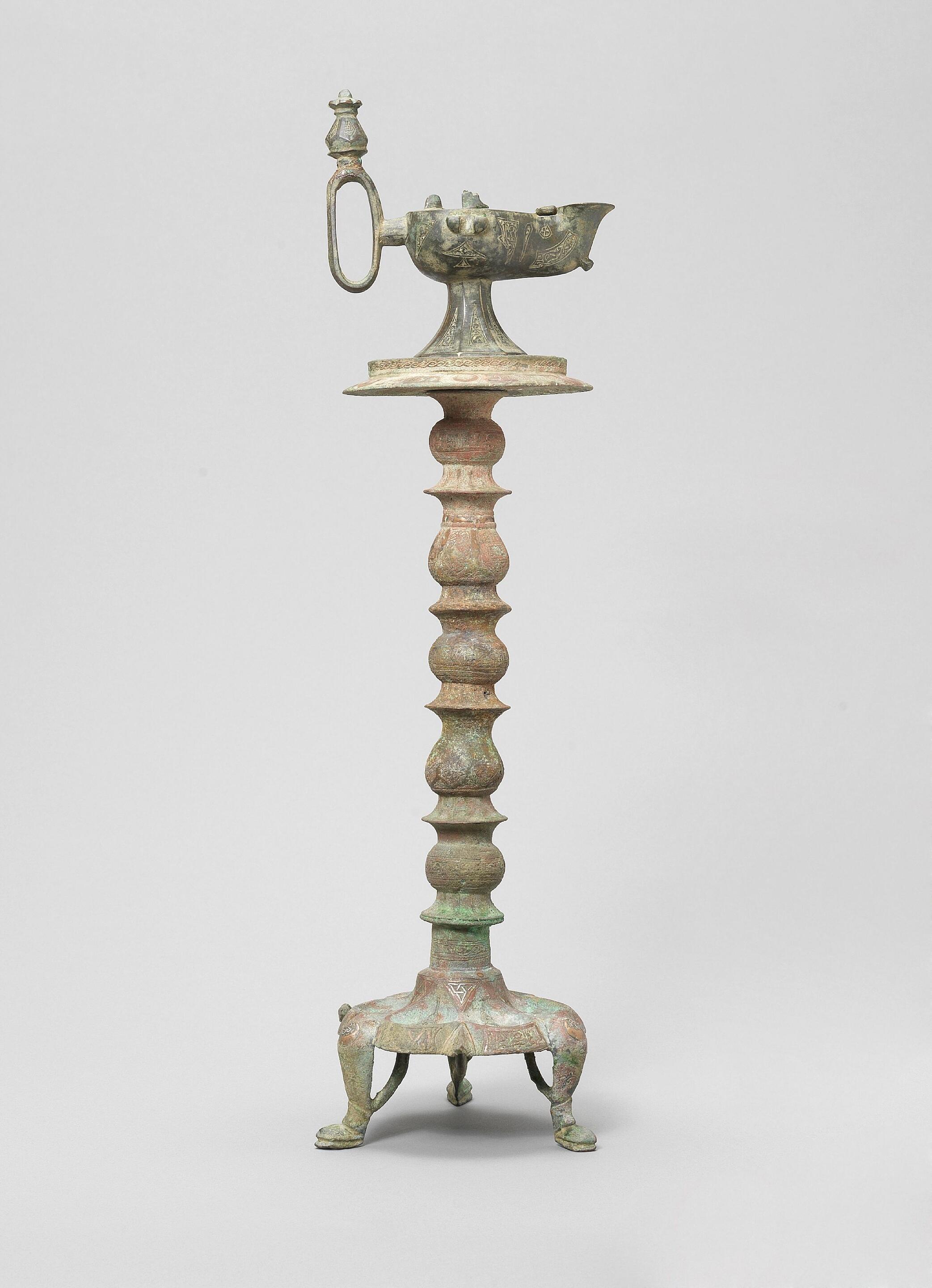 Bonhams A Khorasan silver and copperinlaid bronze LampStand and Oil