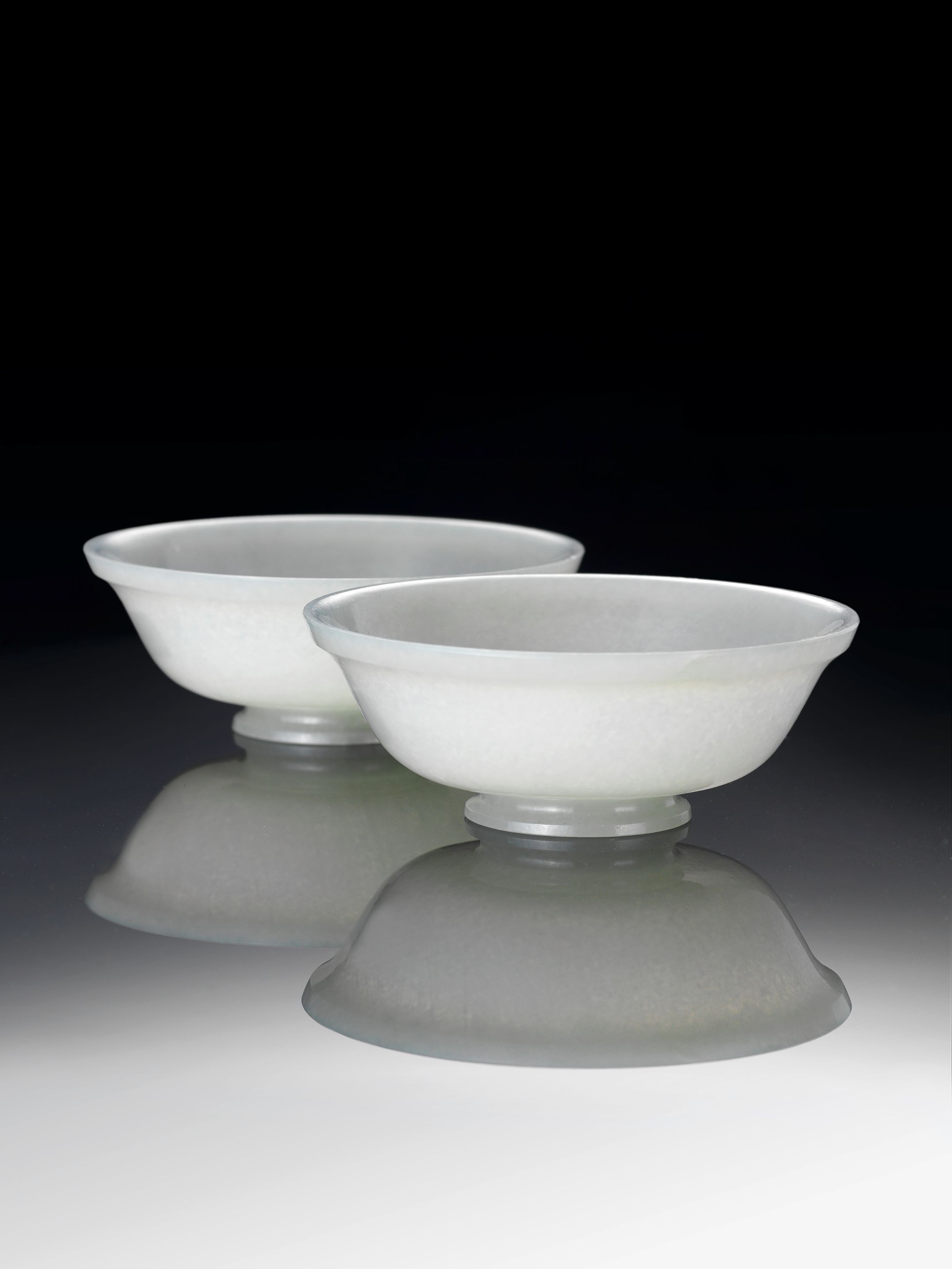 Bonhams A pair of pale green jade bowls 18th century