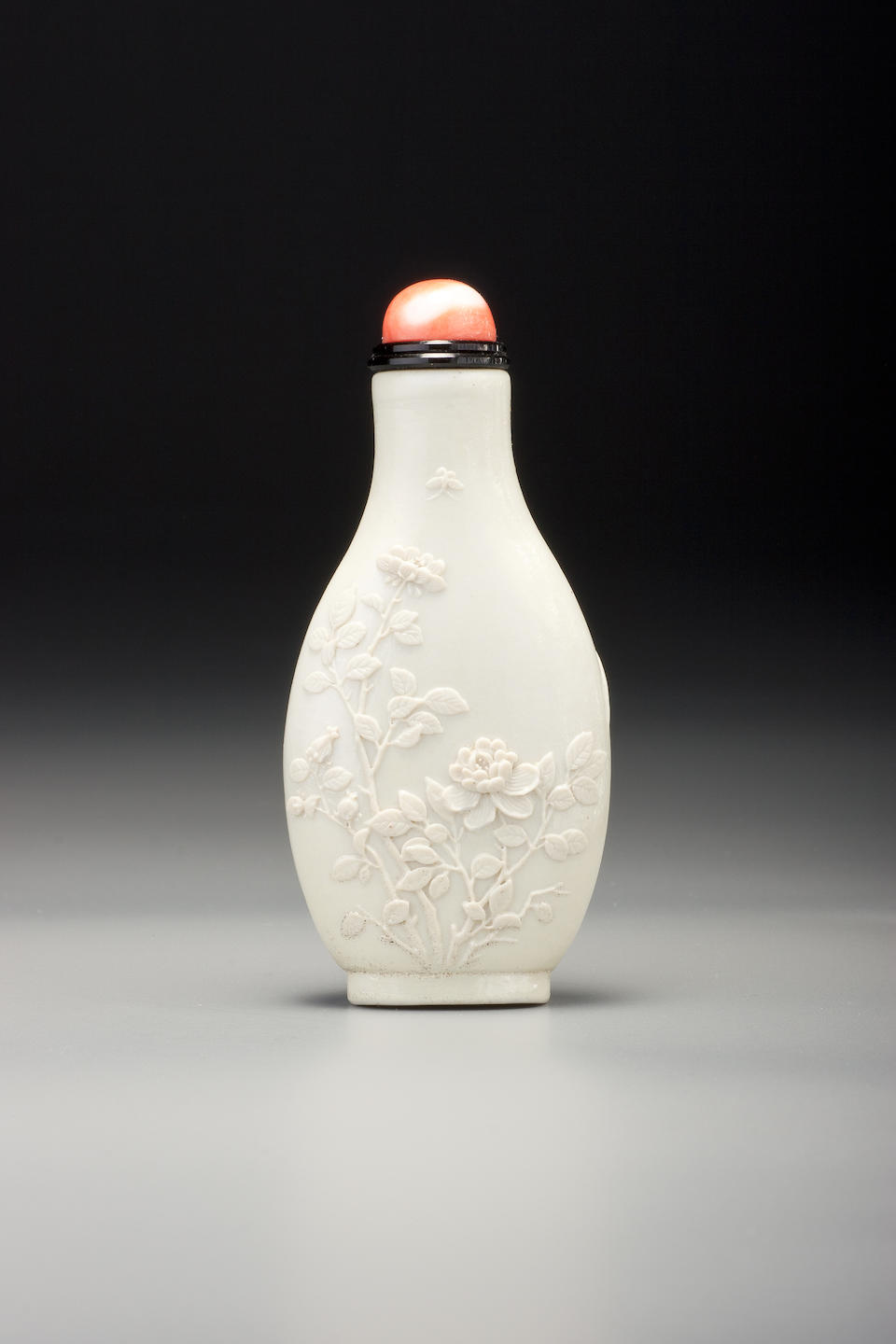 Bonhams : A white porcelain carved 'orchids and roses' snuff bottle Li ...