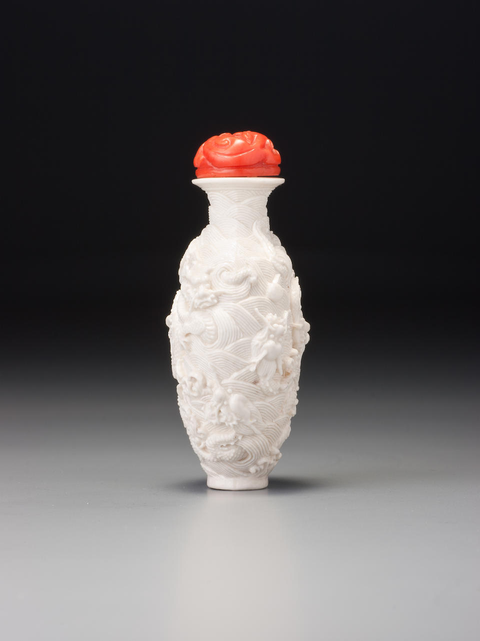 Bonhams : A moulded white porcelain 'nine dragon' snuff bottle Probably ...