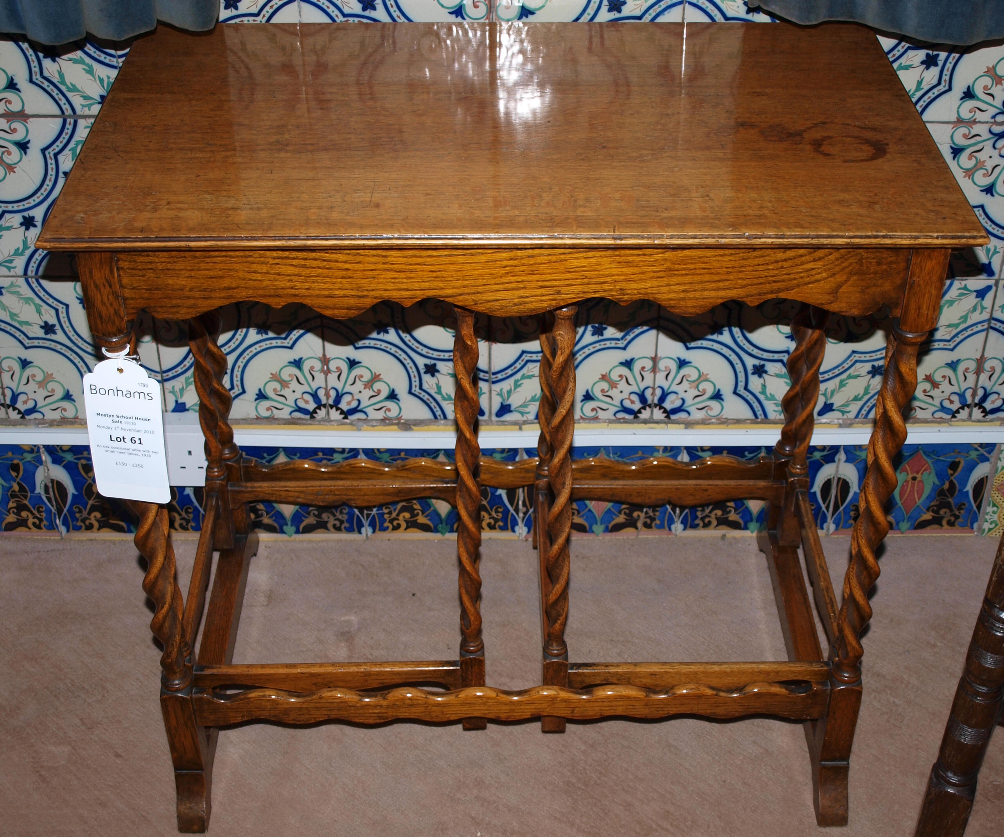 Bonhams An oak occasional table with two small 'nest' tables, 1930