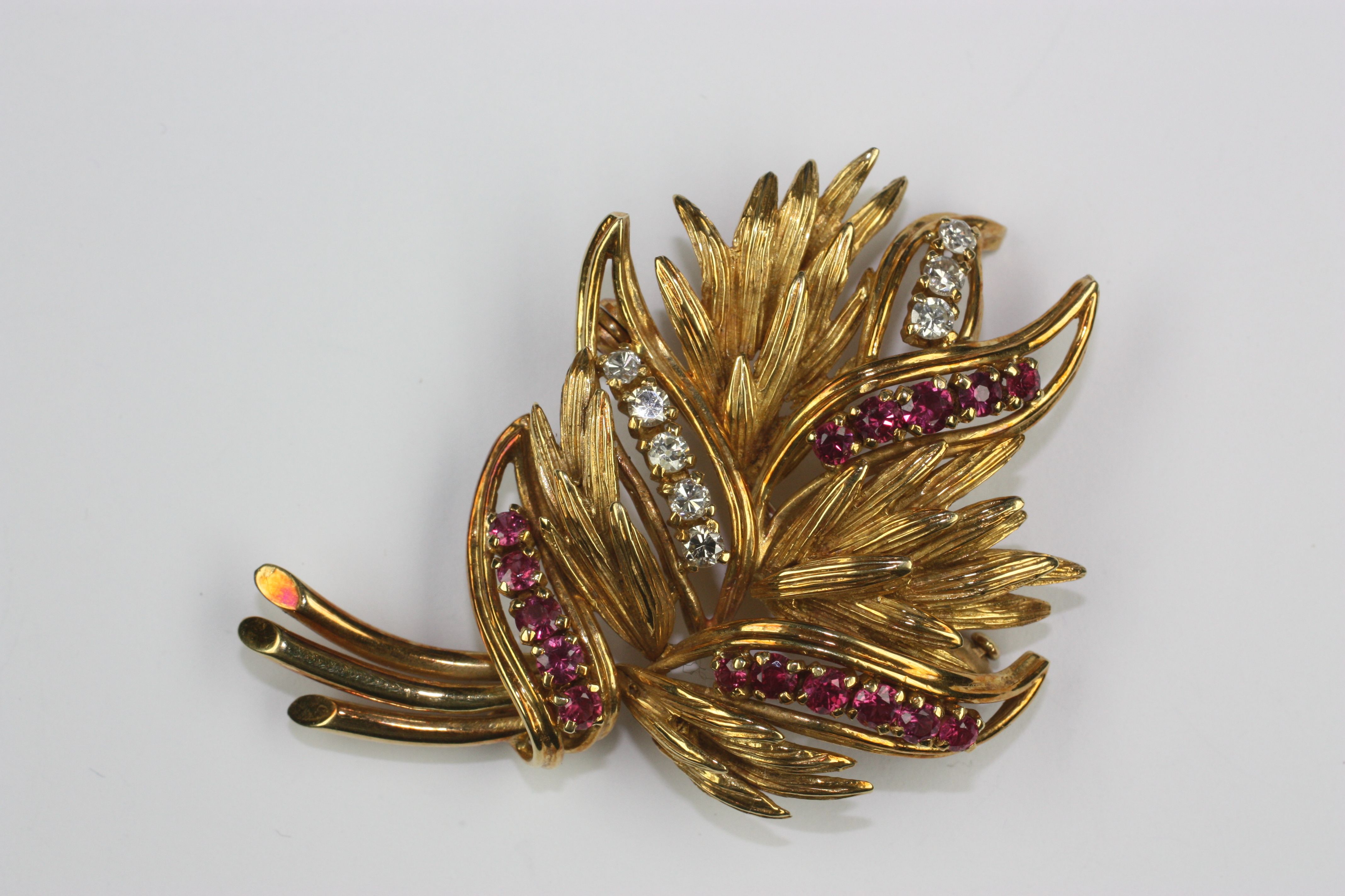 A ruby and diamond spray brooch