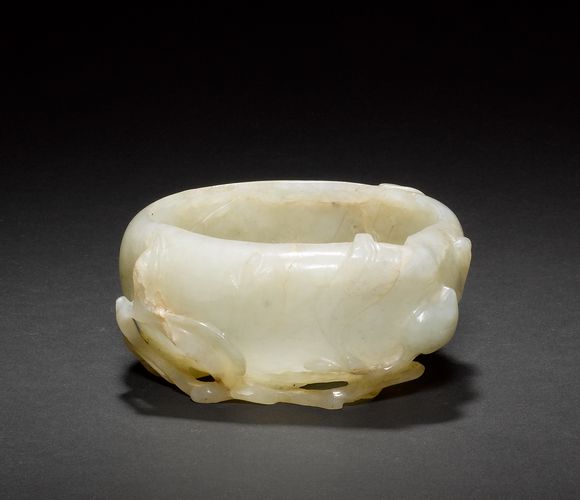 Bonhams A green jade water pot of mottled celadon hue, designed as a fruit and gnarled branch