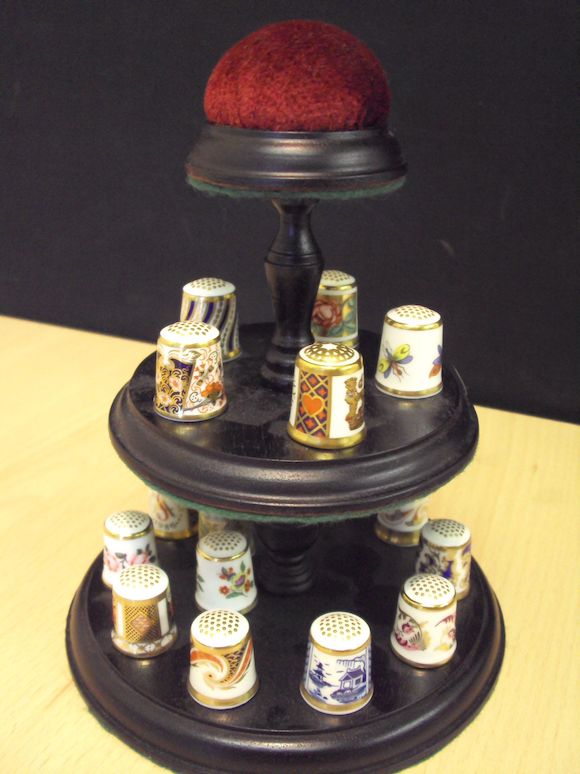 Bonhams A collection of Royal Crown Derby thimbles and stand