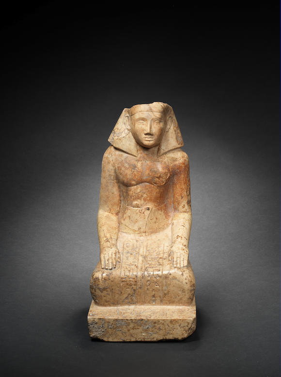 Bonhams : An Egyptian indurated limestone statue of a kneeling official