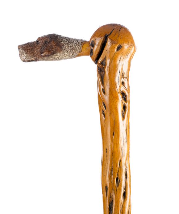 Bonhams A polychromed carved wooden 'dog' walking stick,