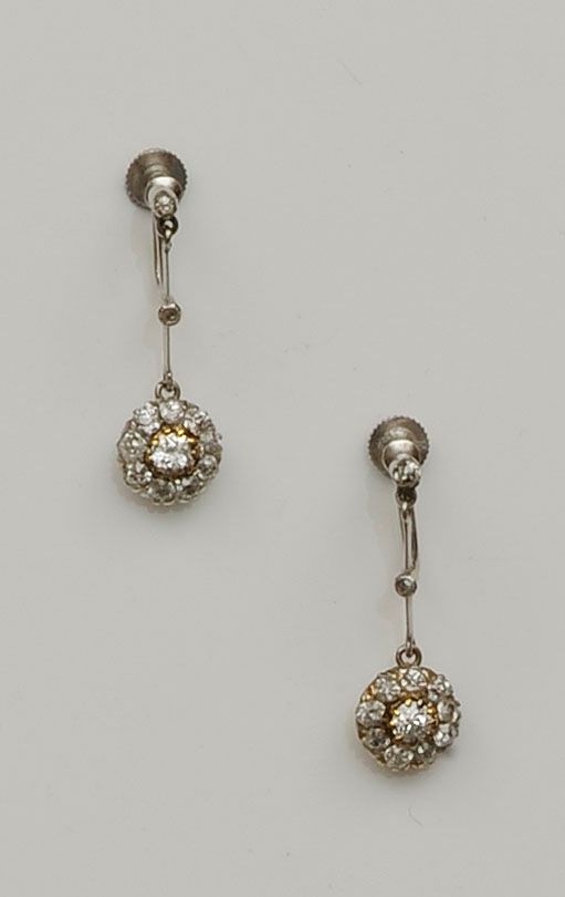 Bonhams A pair of diamond cluster drop earrings, The round clusters