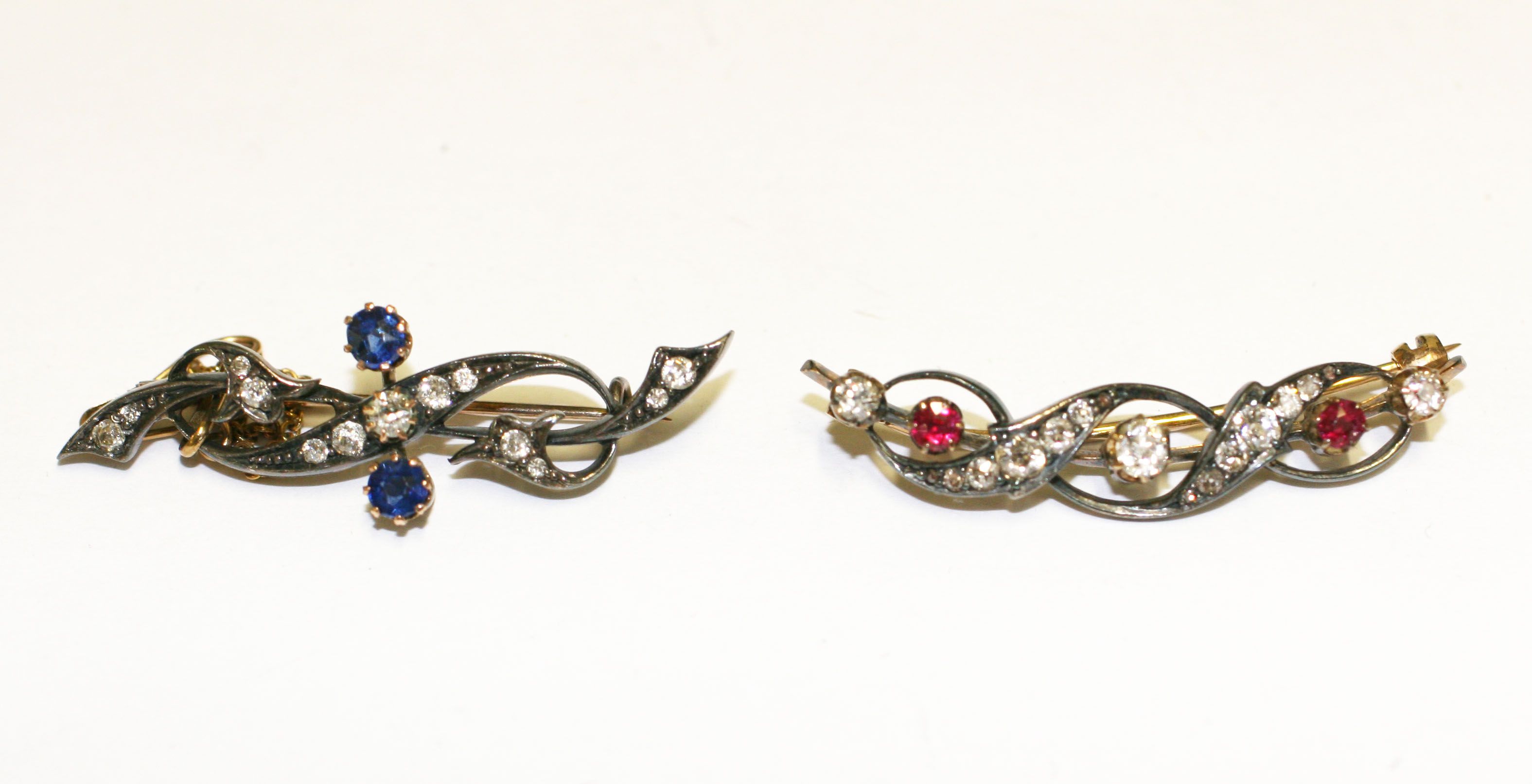 A ruby and diamond bar brooch, (2)