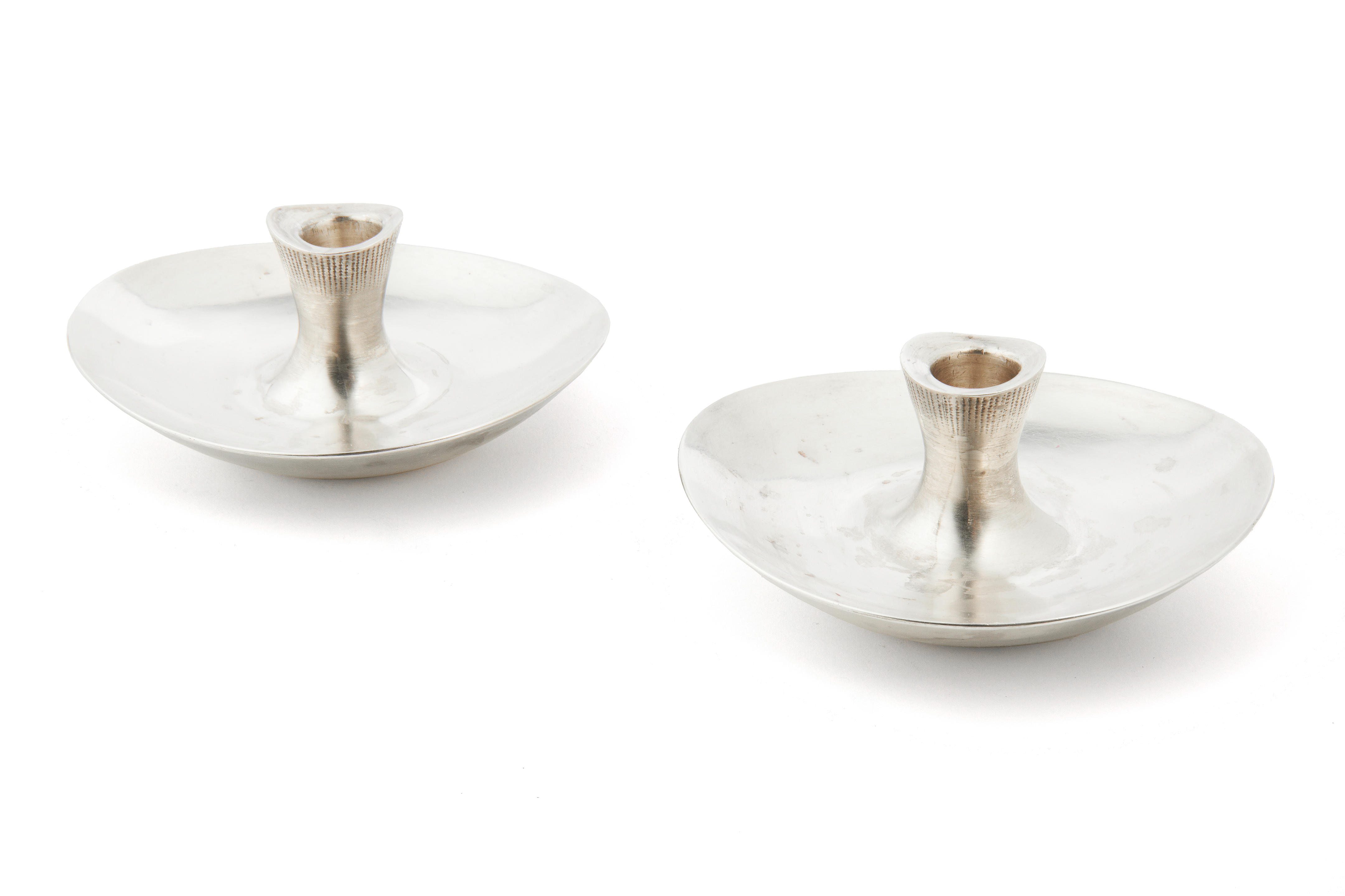 Bonhams : DESIGNED BY TAPIO WIRKKALA FOR HOPEATEHDAS OY HELSINKI A pair of  silver tapersticks stamped 813H, Helsinki 1951