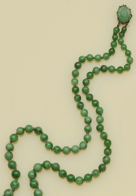 Bonhams : A double row treated jade bead necklace