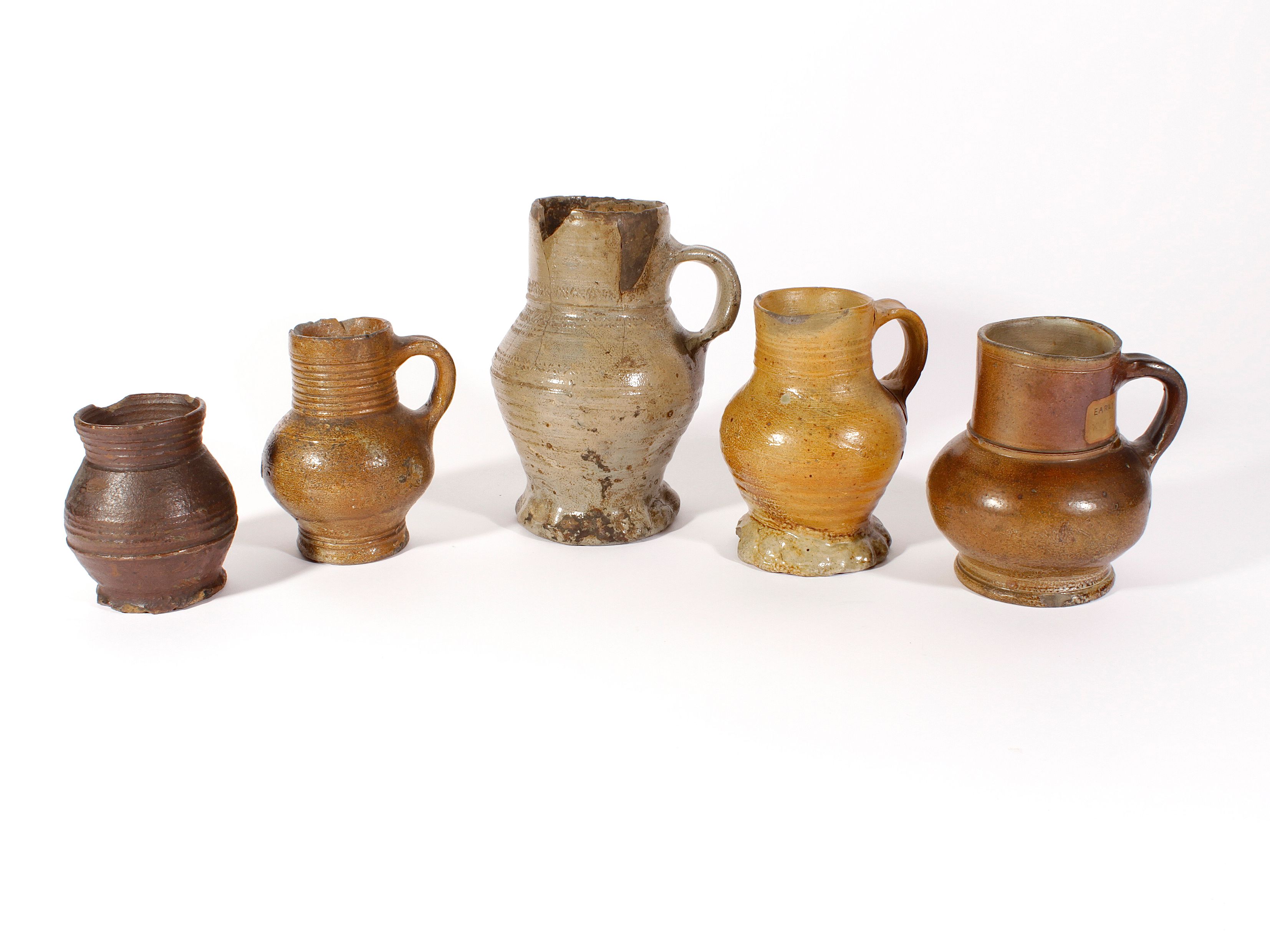 Bonhams Five early Rhenish or Siegburg stoneware jugs, 14th16th century