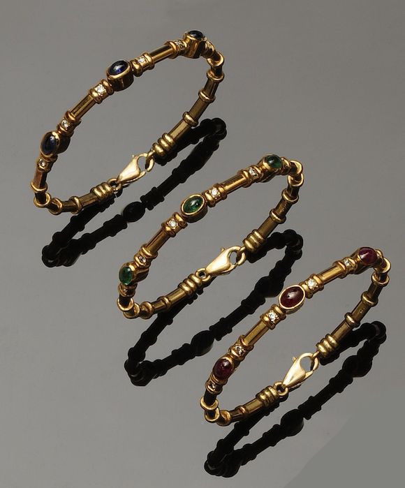 Bonhams : A suite of three vari-gem set bangles (3)