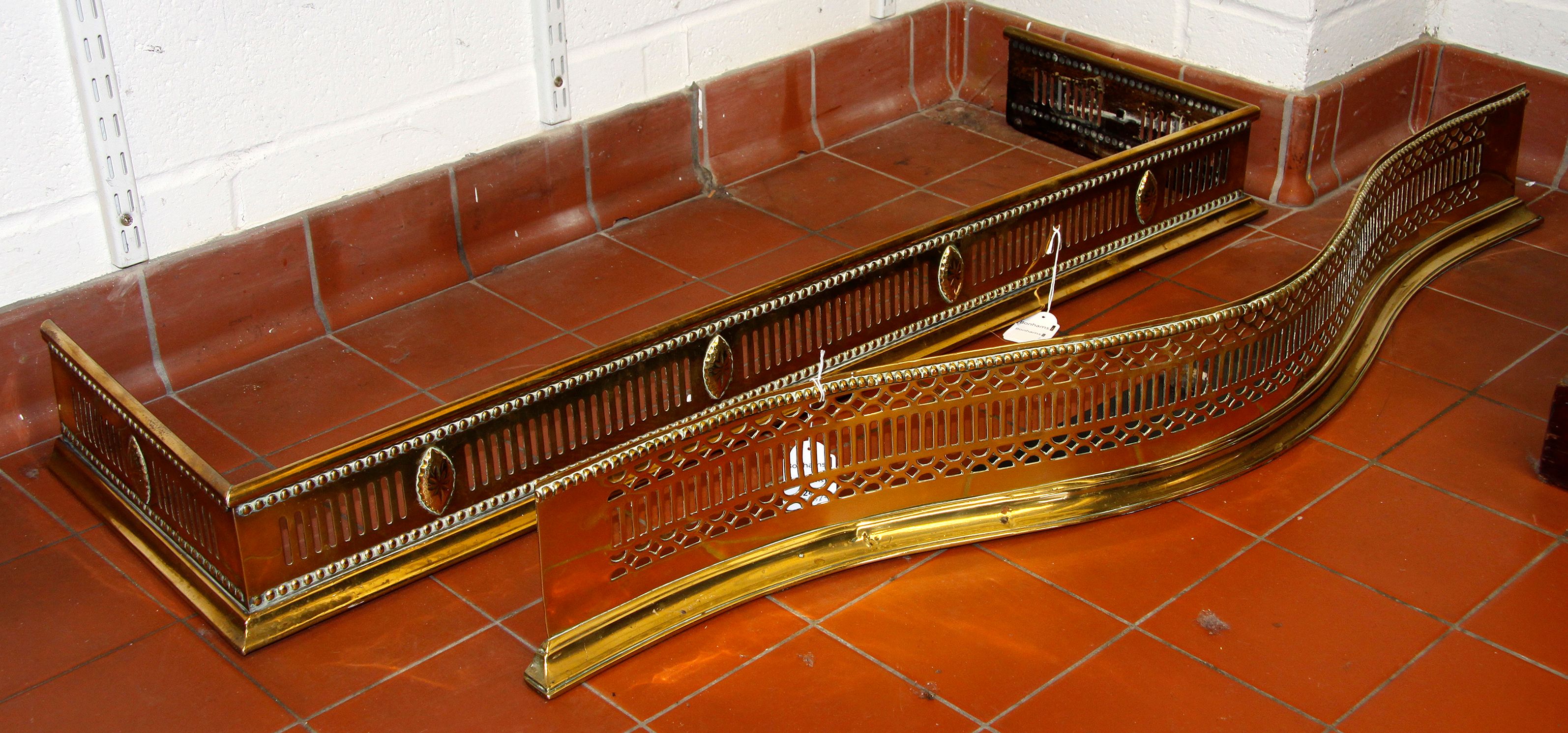 Bonhams Two Regency brass fire fenders,