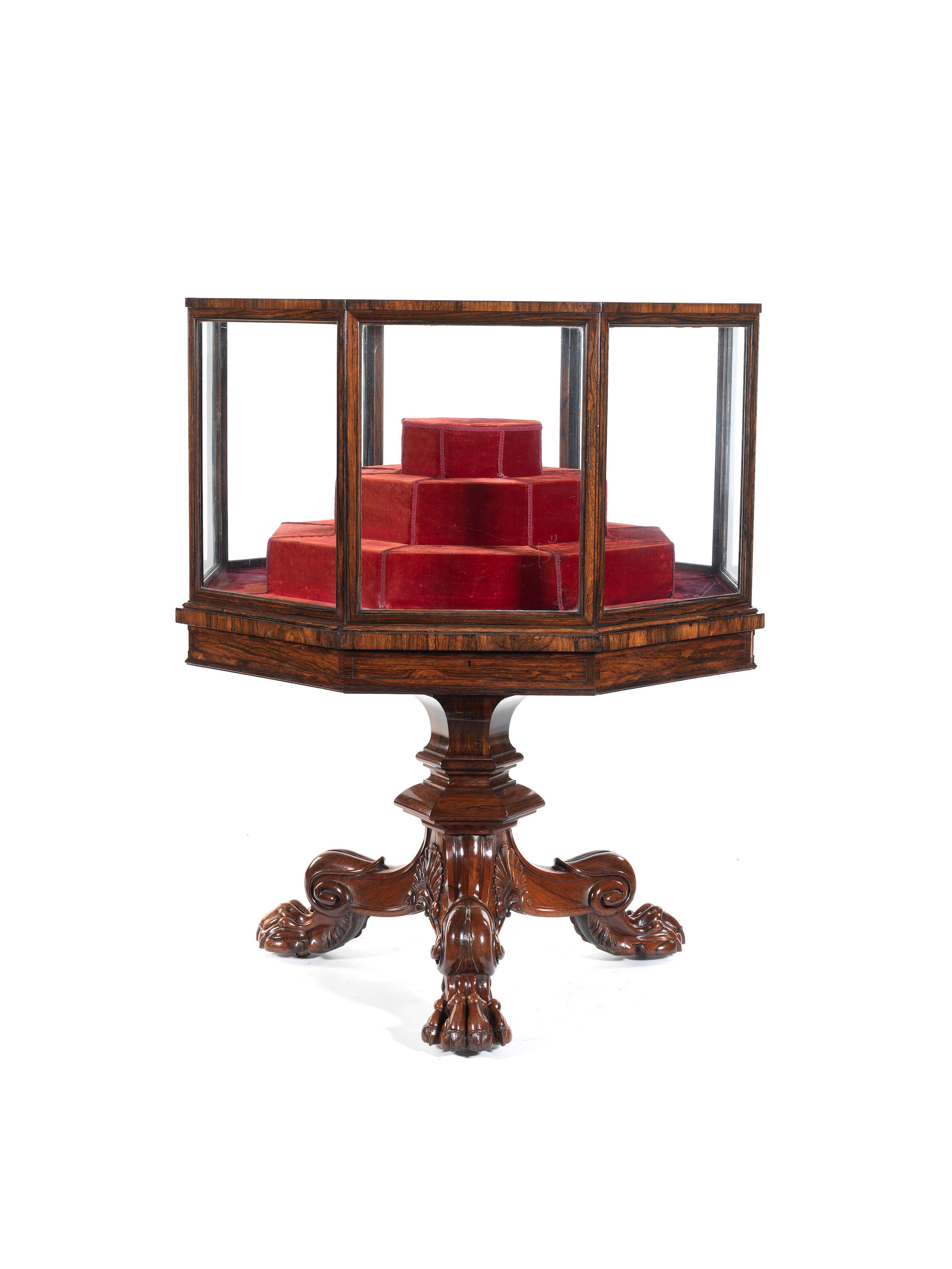 A George IV carved rosewood octagonal display case on tripod sta