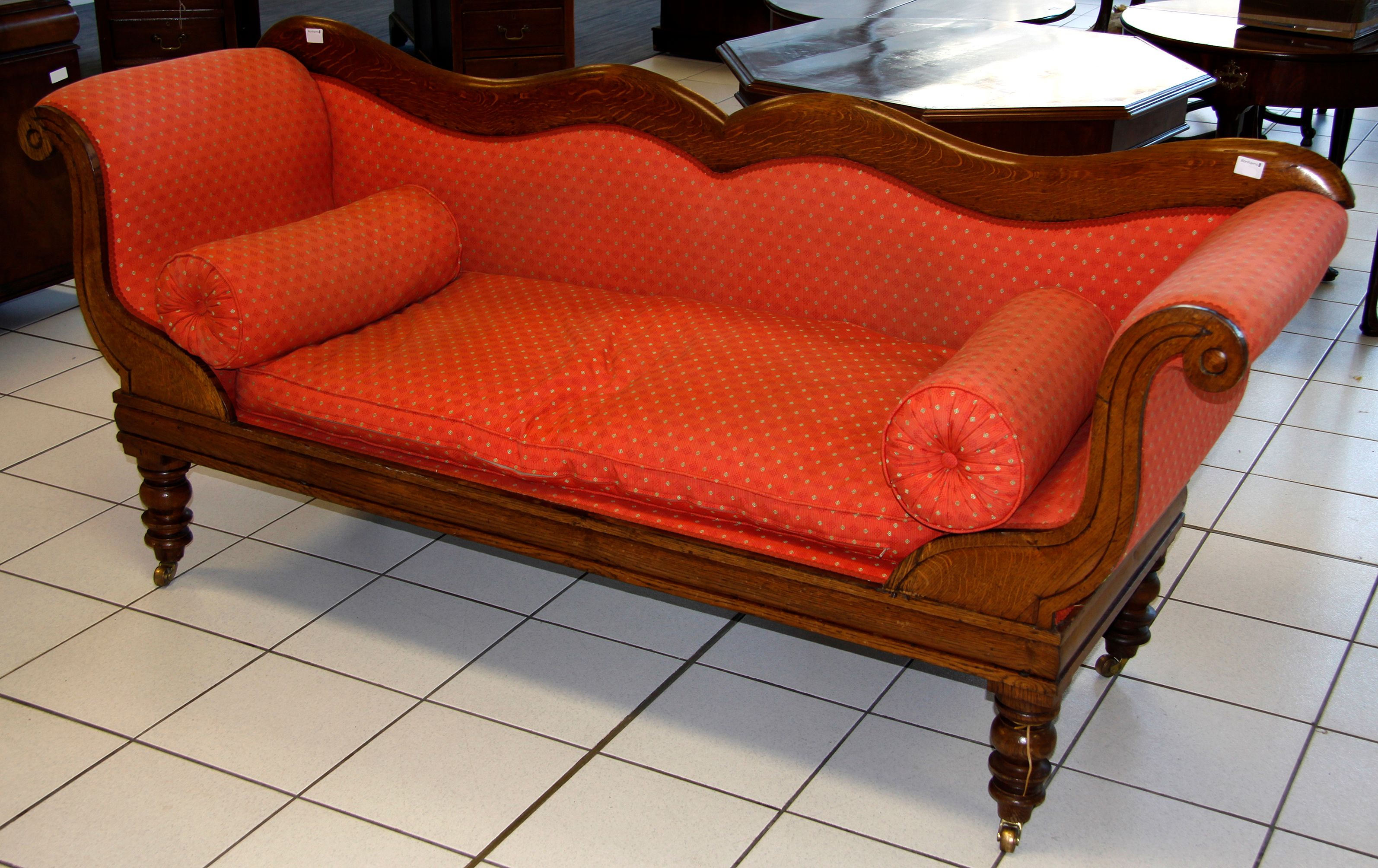 A Victorian oak scroll end serpentine settee
