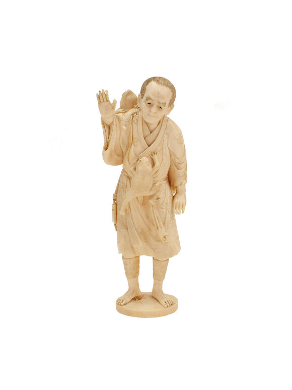 Bonhams : A Japanese carved ivory okimono of a man with two toads ...