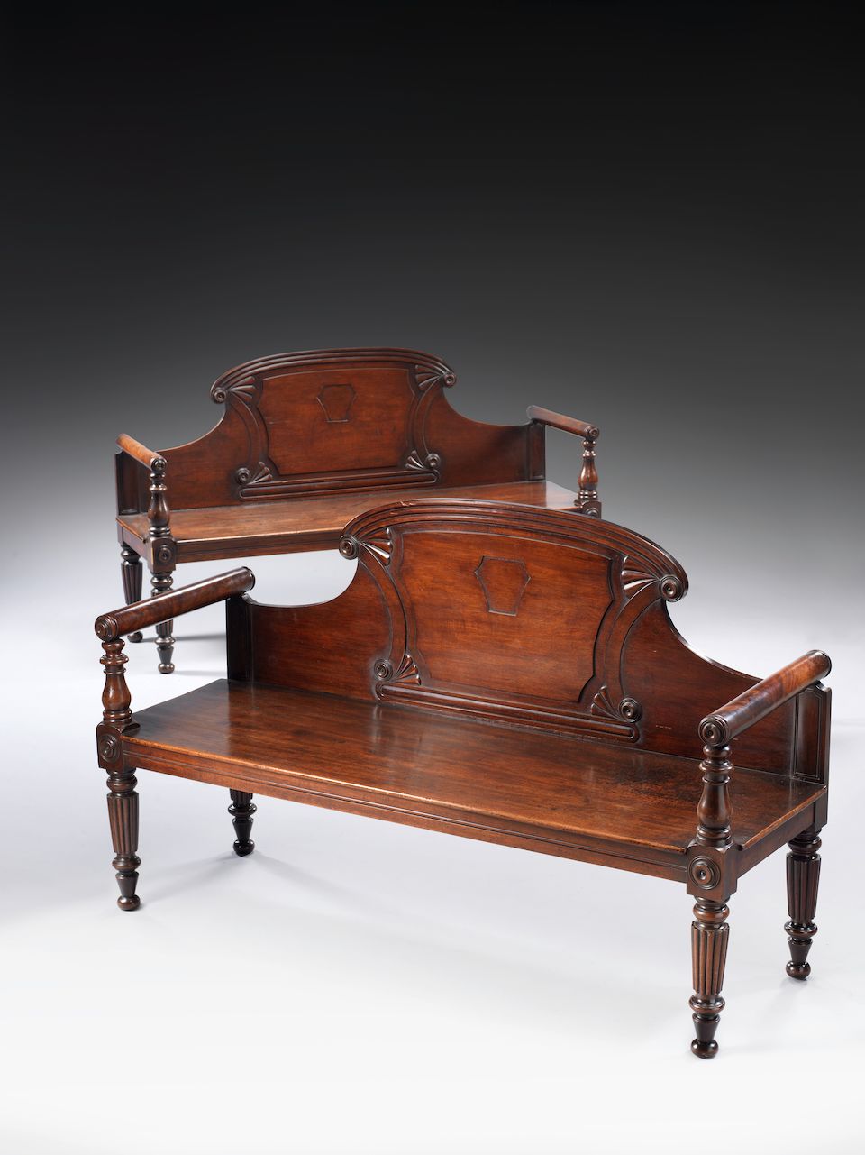 Bonhams A near pair of late Regency Irish carved mahogany hall