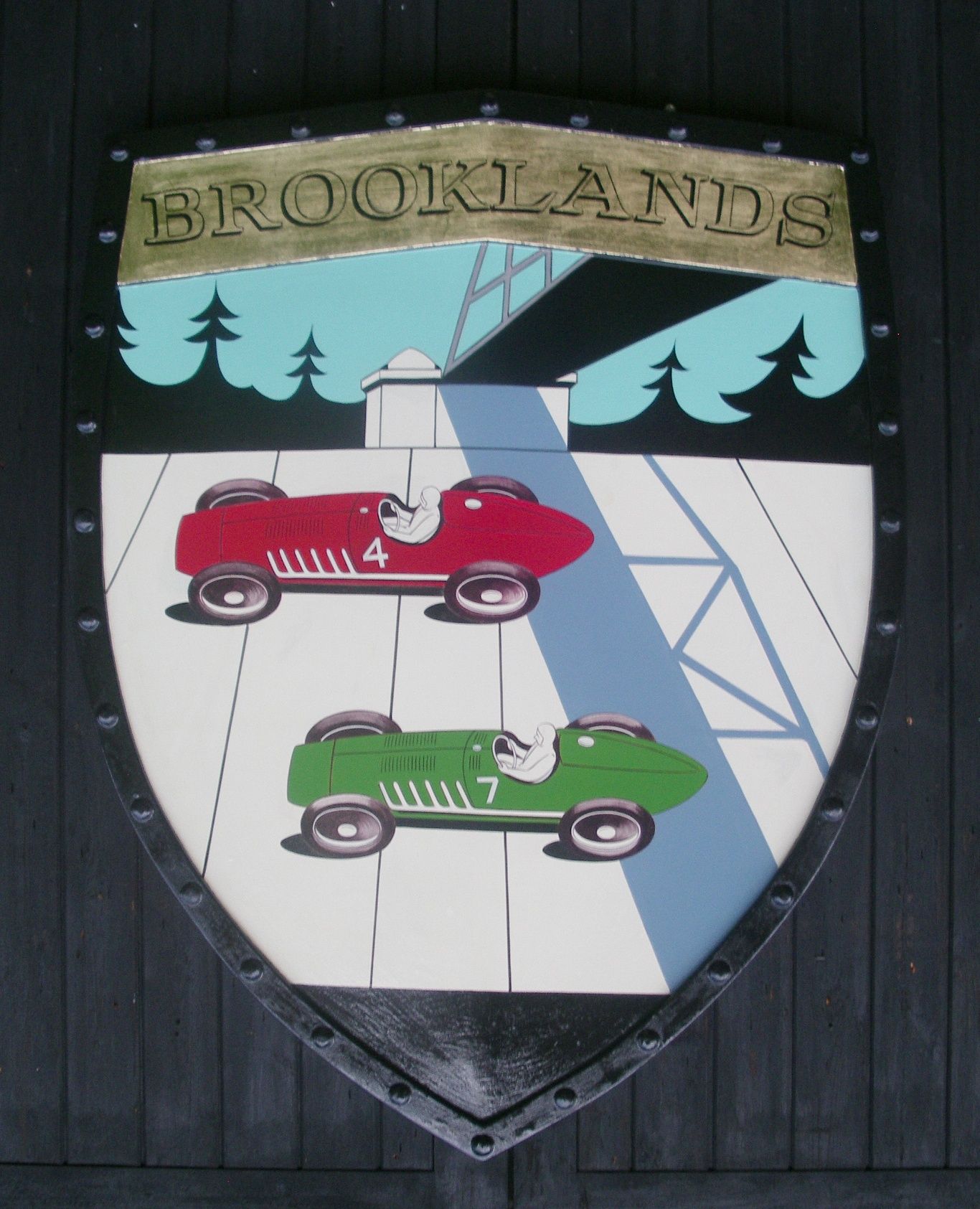 Bonhams Cars A handpainted Brooklands garage display emblem,