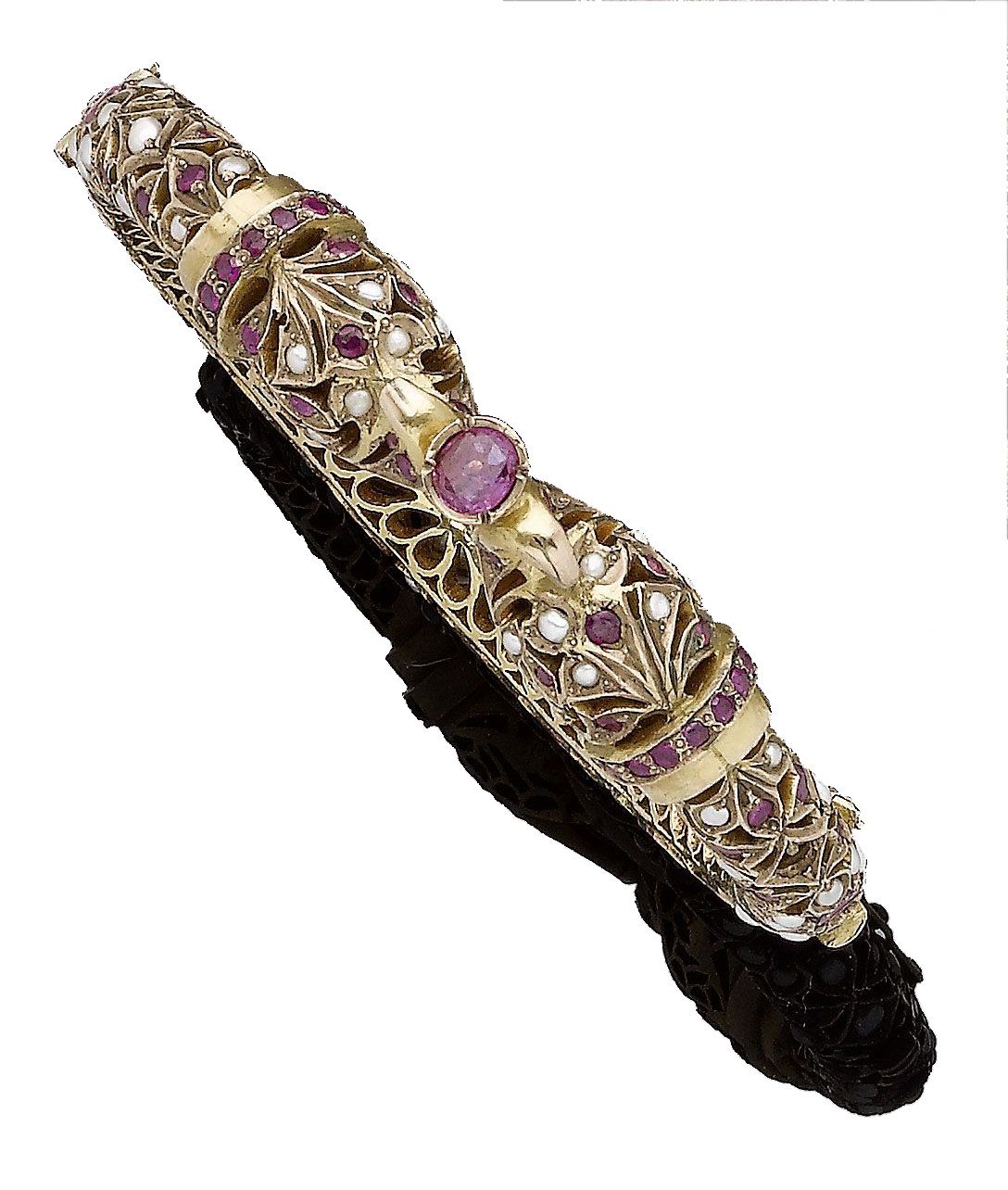 An Eastern pearl and ruby hinged bangle