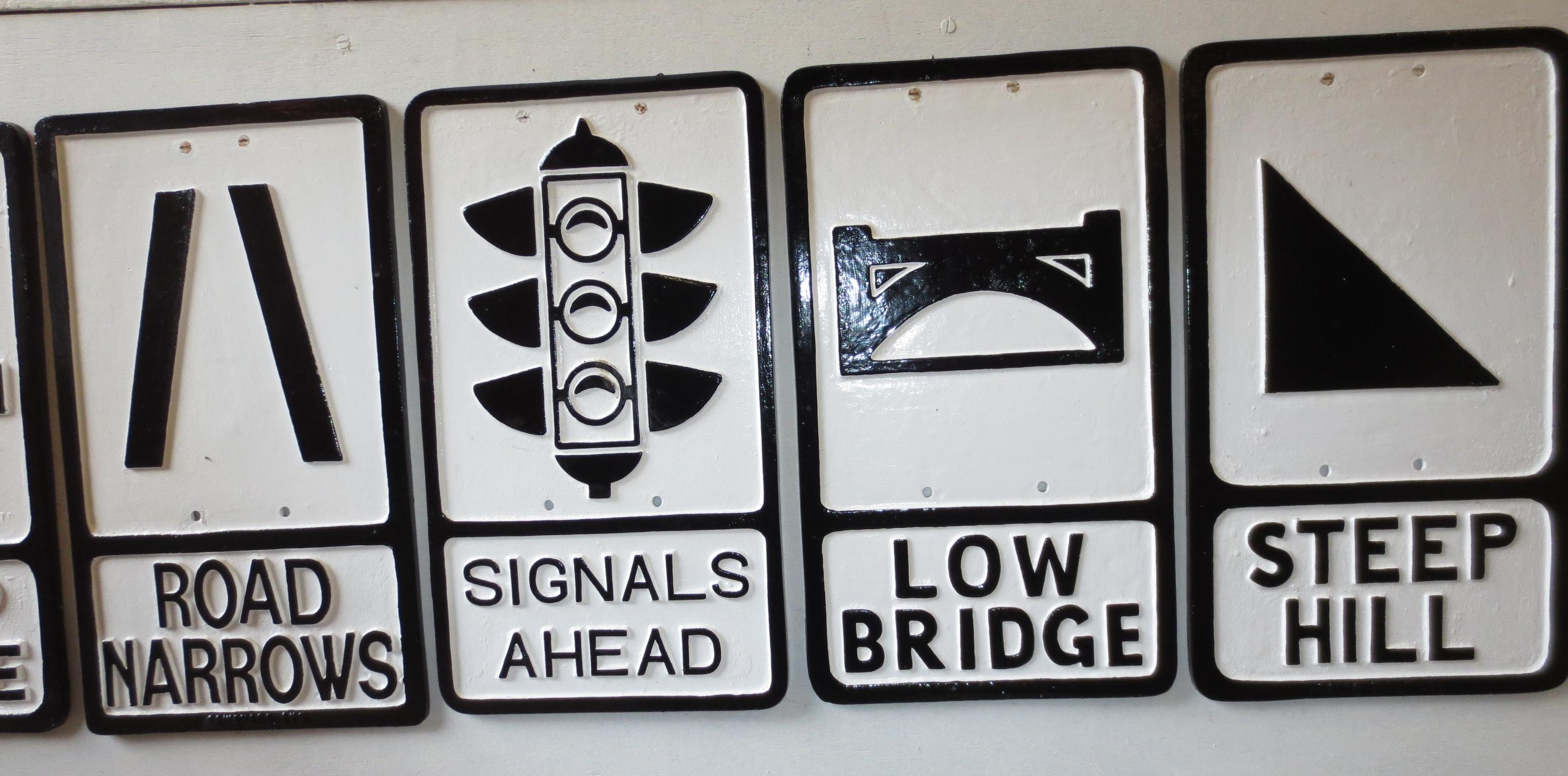 Bonhams Cars : Four re-painted cast metal road signs,