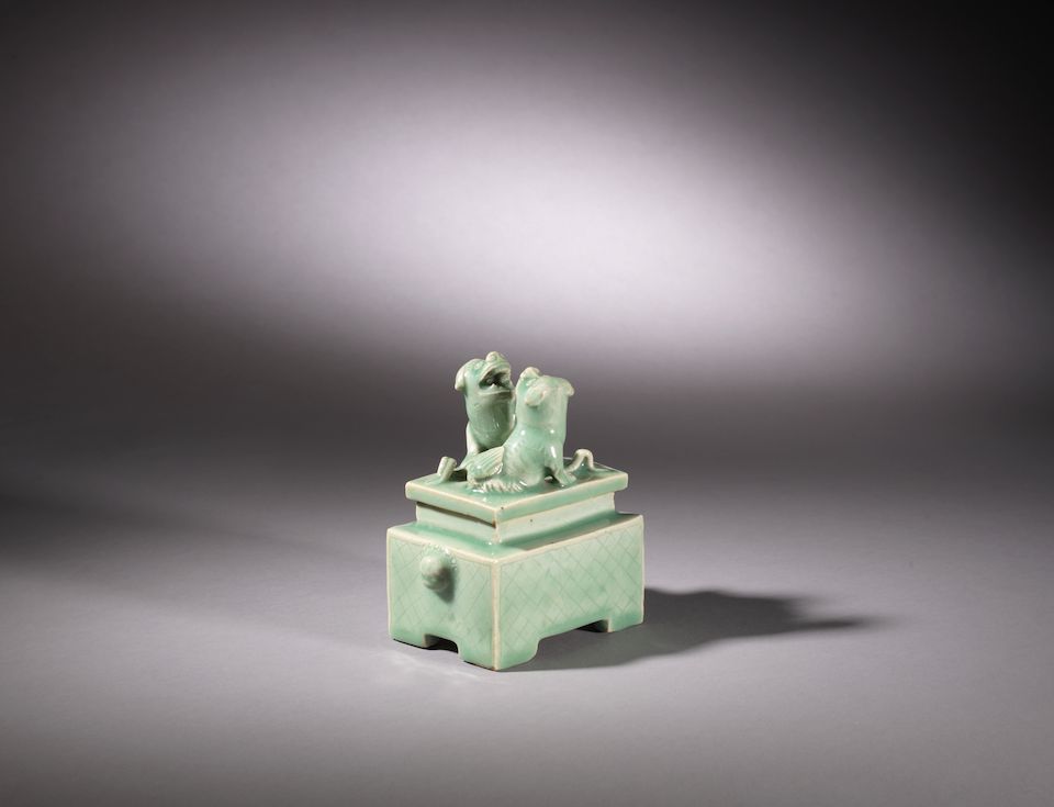 A celadon-glazed 'Buddhist lion' rectangular box and cover Mid Ming Dynasty, 15th/16th century