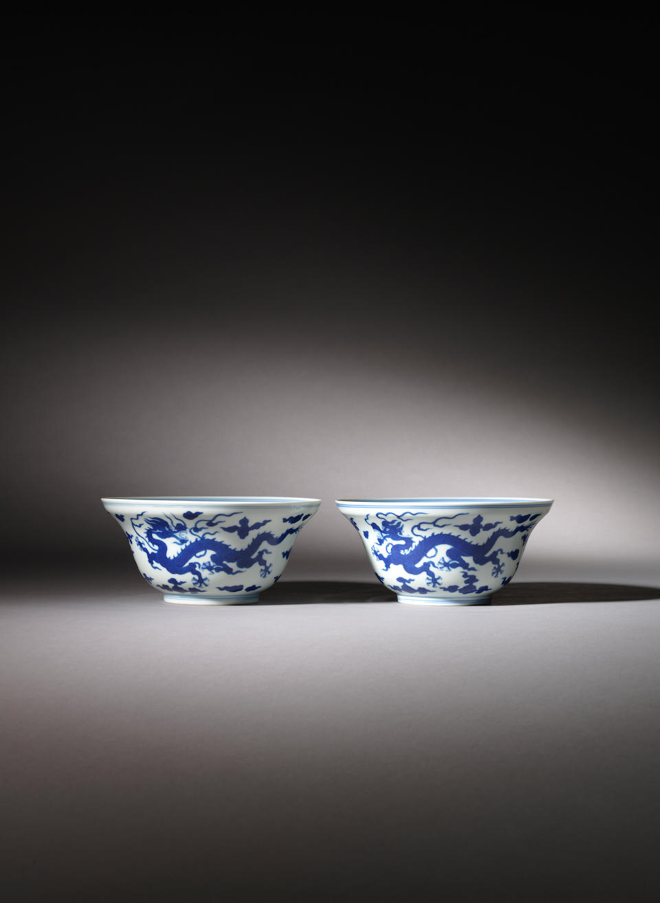 A pair of blue and white ogee-shaped 'dragon' bowls Qianlong seal marks and of the period