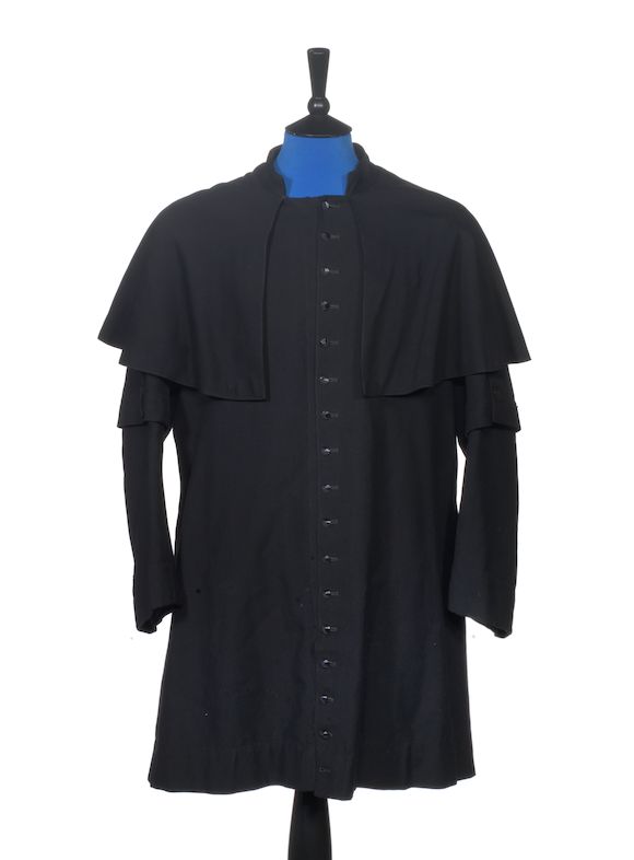 Bonhams Ginger Baker/Cream A black collarless cassock worn by Ginger