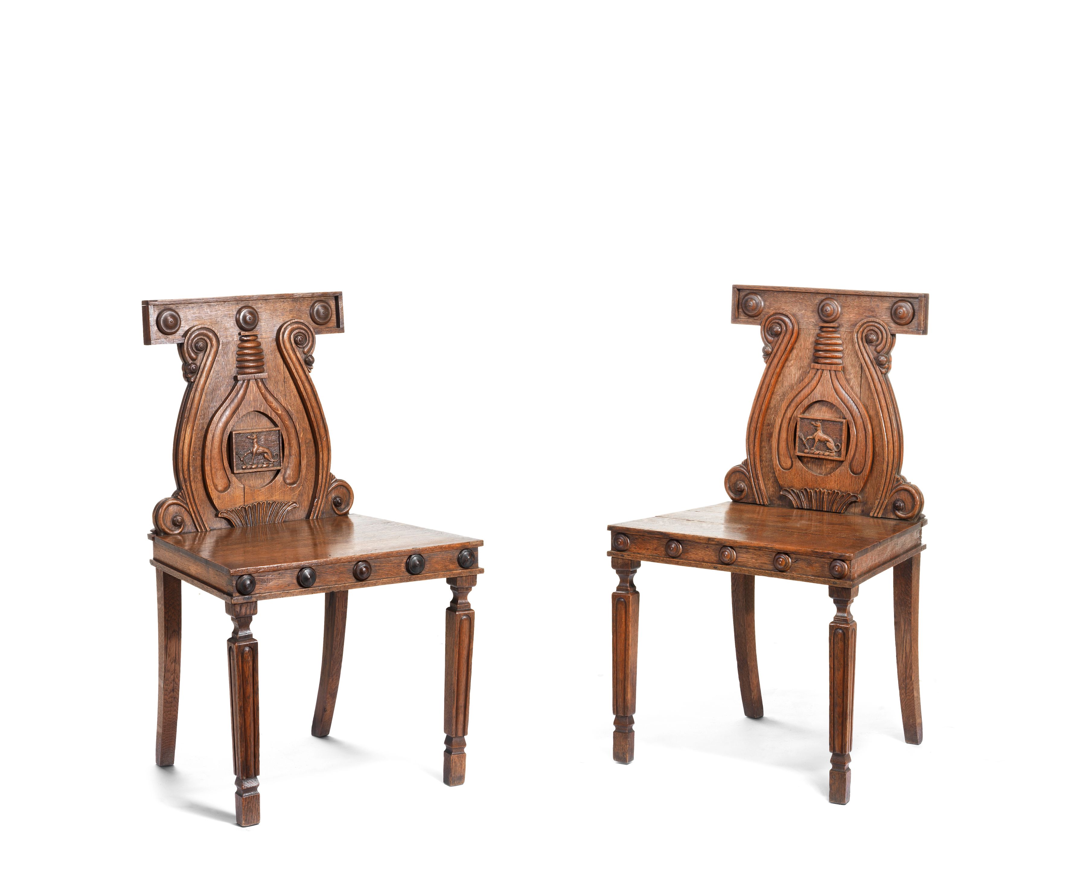 Bonhams A pair of Regency oak hall chairs after a design by Peter and Michael Angelo Nicholson