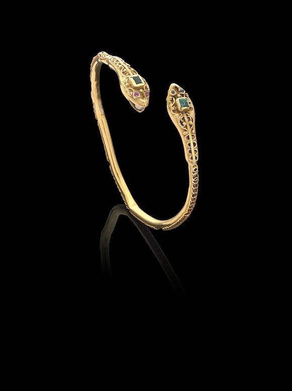 Bonhams A gemset gold snake head bangle Morocco, 19th Century