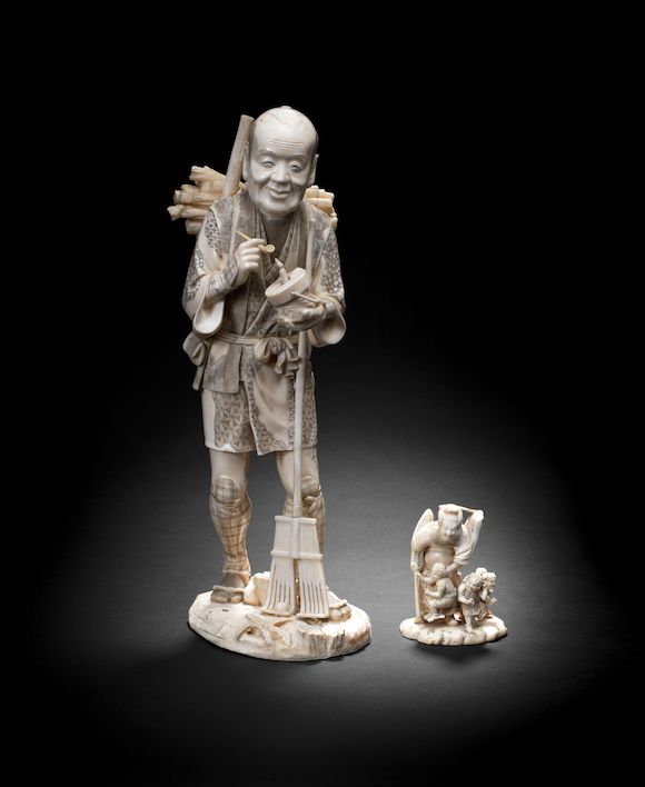 Bonhams : One tall walrus-tusk okimono figure of a woodsman and one