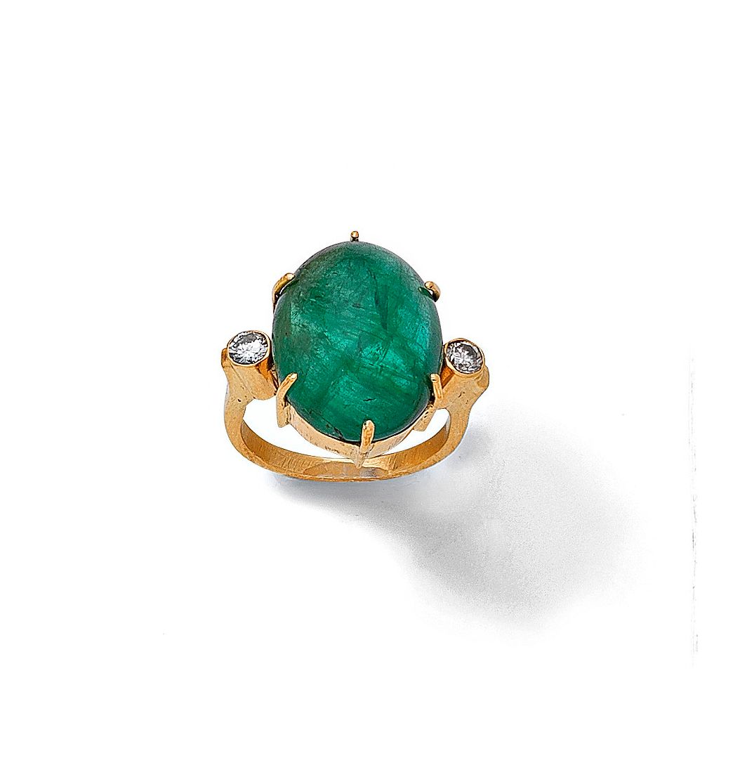 An emerald and diamond ring
