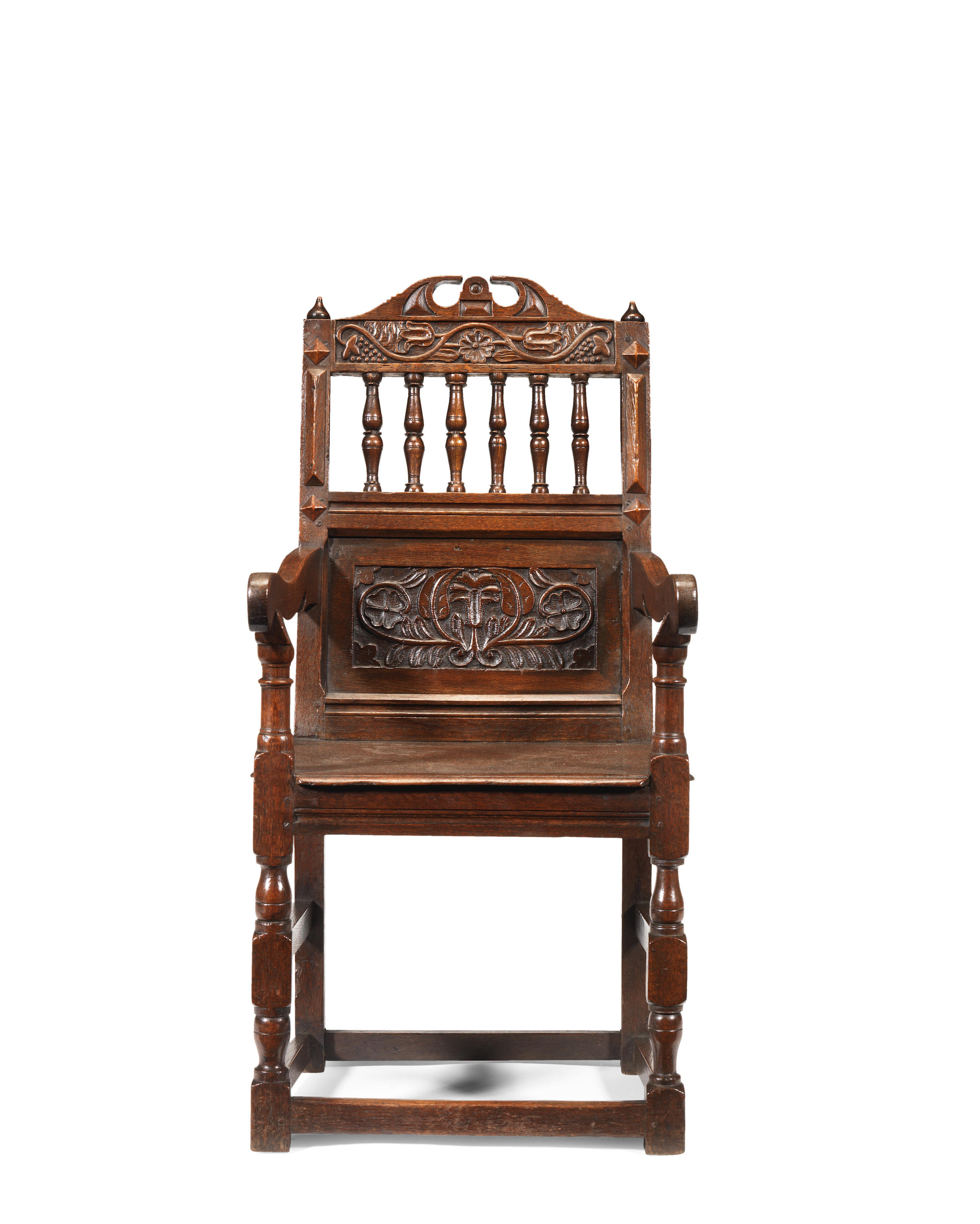 A Charles II joined oak panel and open-back armchair, Cheshire, circa 1670