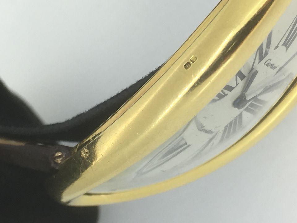 Bonhams Cartier. A rare oversized 18K gold manual wind oval