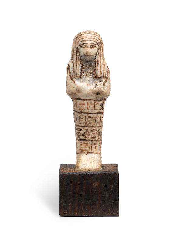 Bonhams : An Egyptian white glazed composition shabti for Mery-Ptah